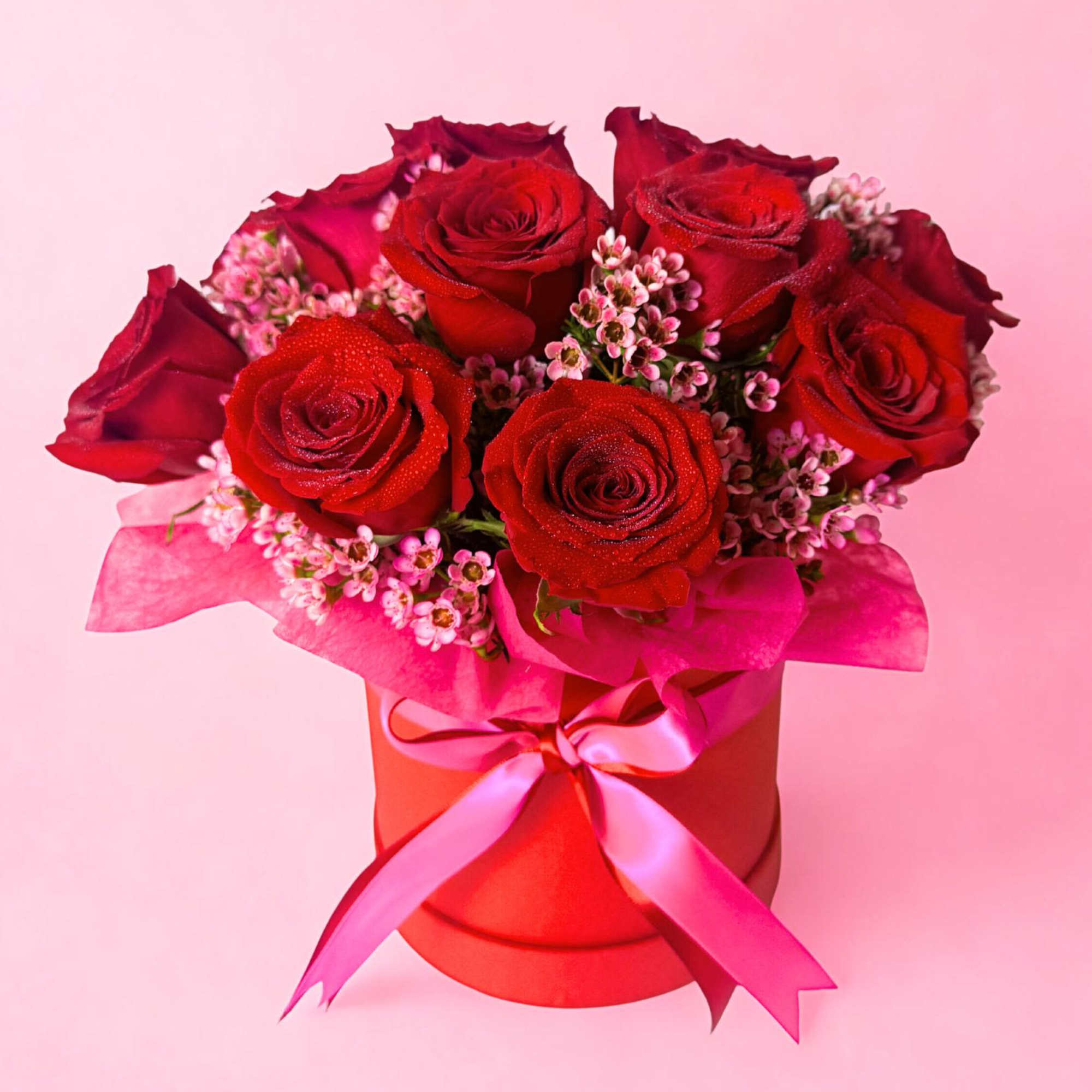 At the center is a lush bouquet of ONE dozen red roses