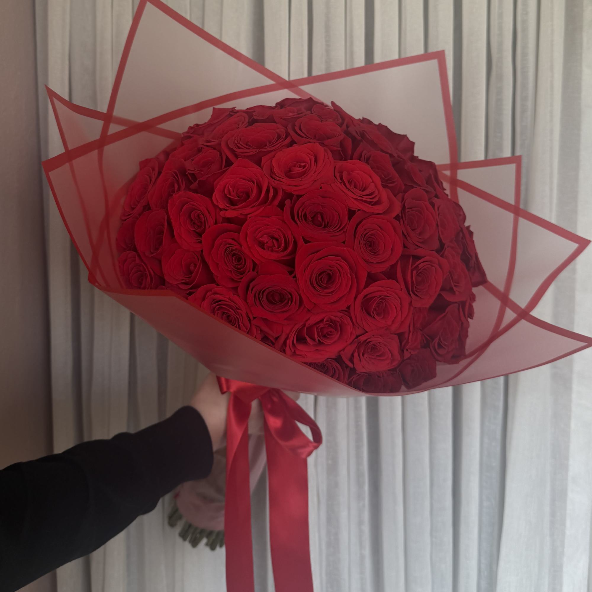 75 roses carefully wrapped and tied with a satin ribbon

Please request the