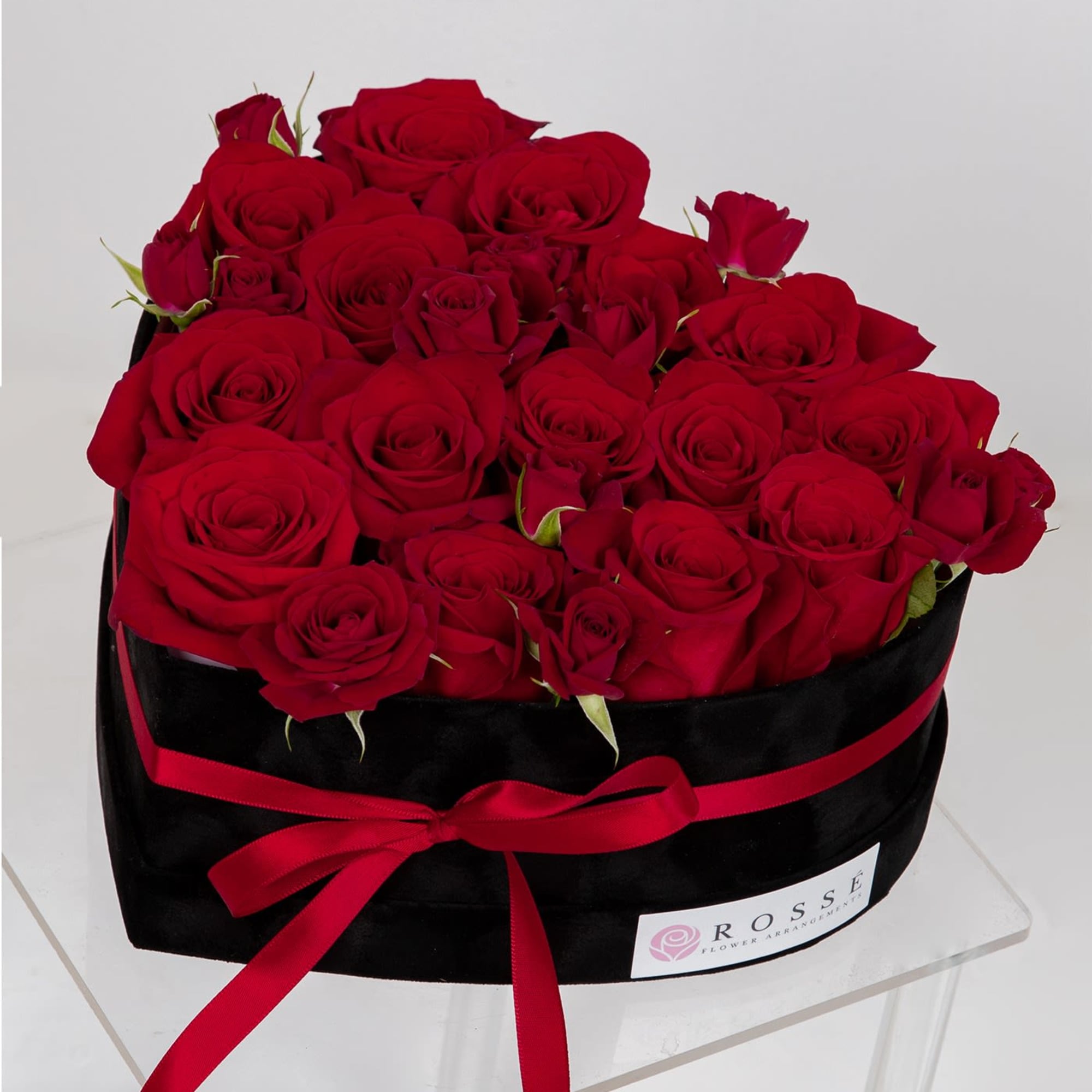 A heart-shaped black Velvet box with Roses and Spray roses.
Flowers colors can