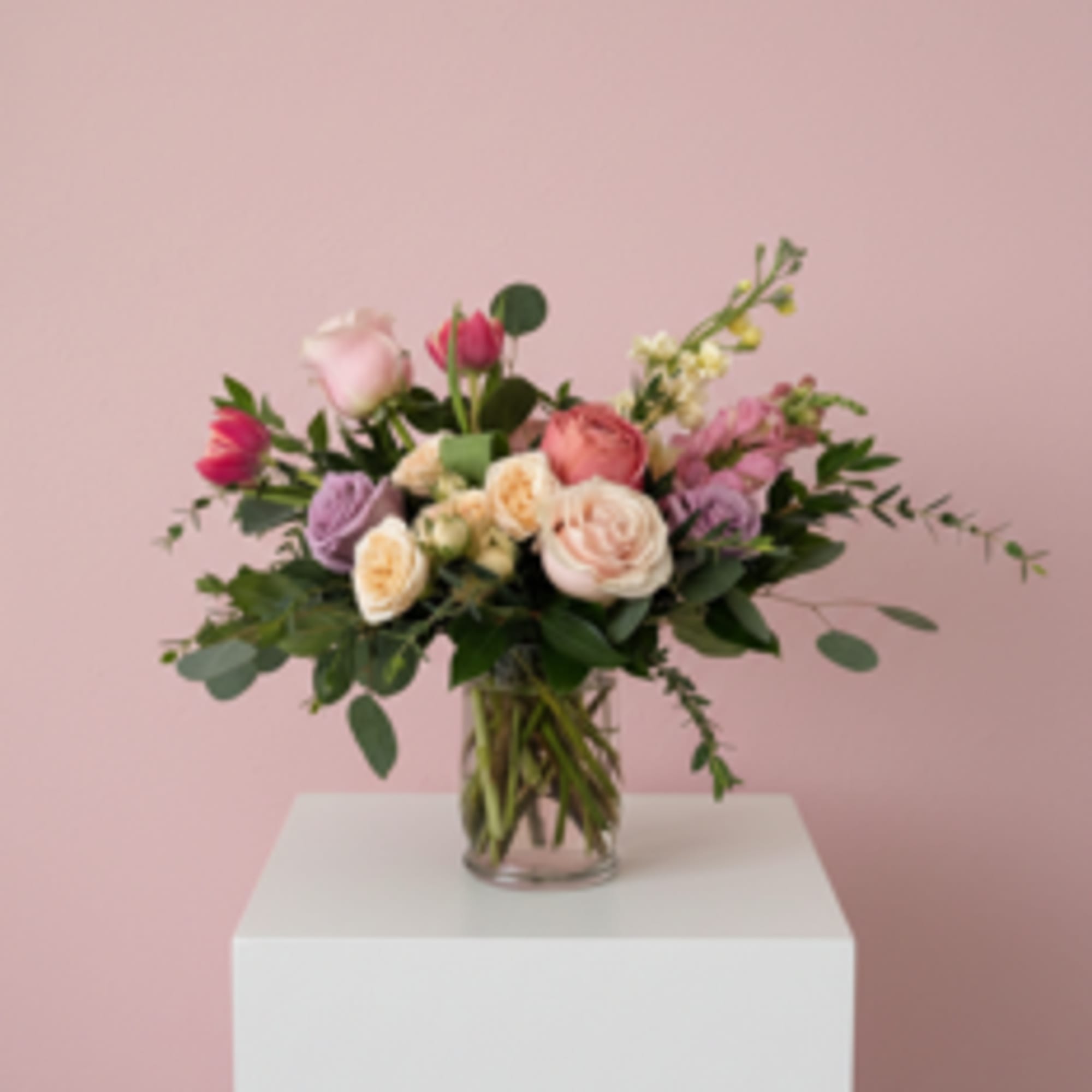 Shades of pink, cream, peach and lavender in a glass hurricane. Long