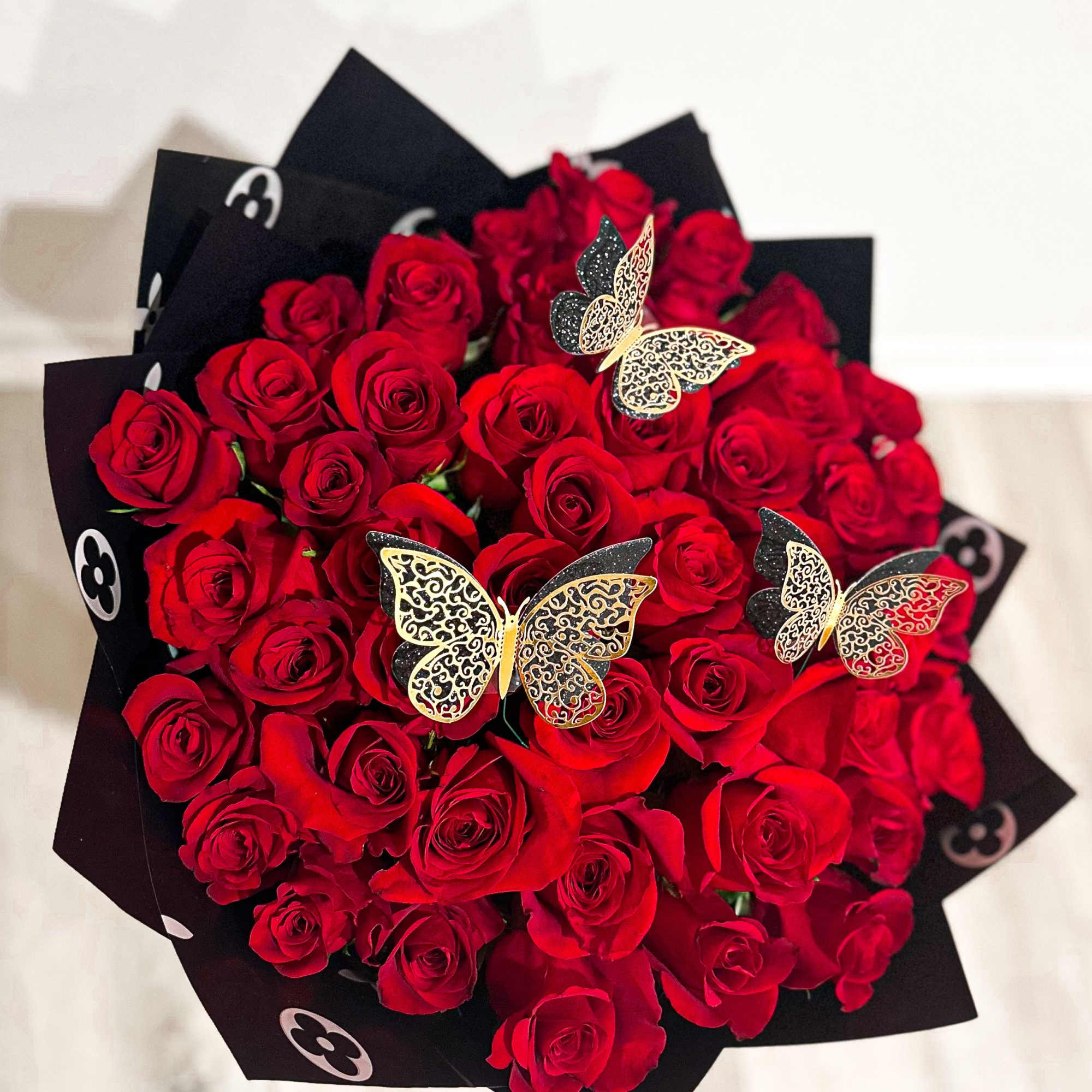 50 roses bouquet with luxury paper.
Deluxe is 75 roses
Premium is 100 roses
