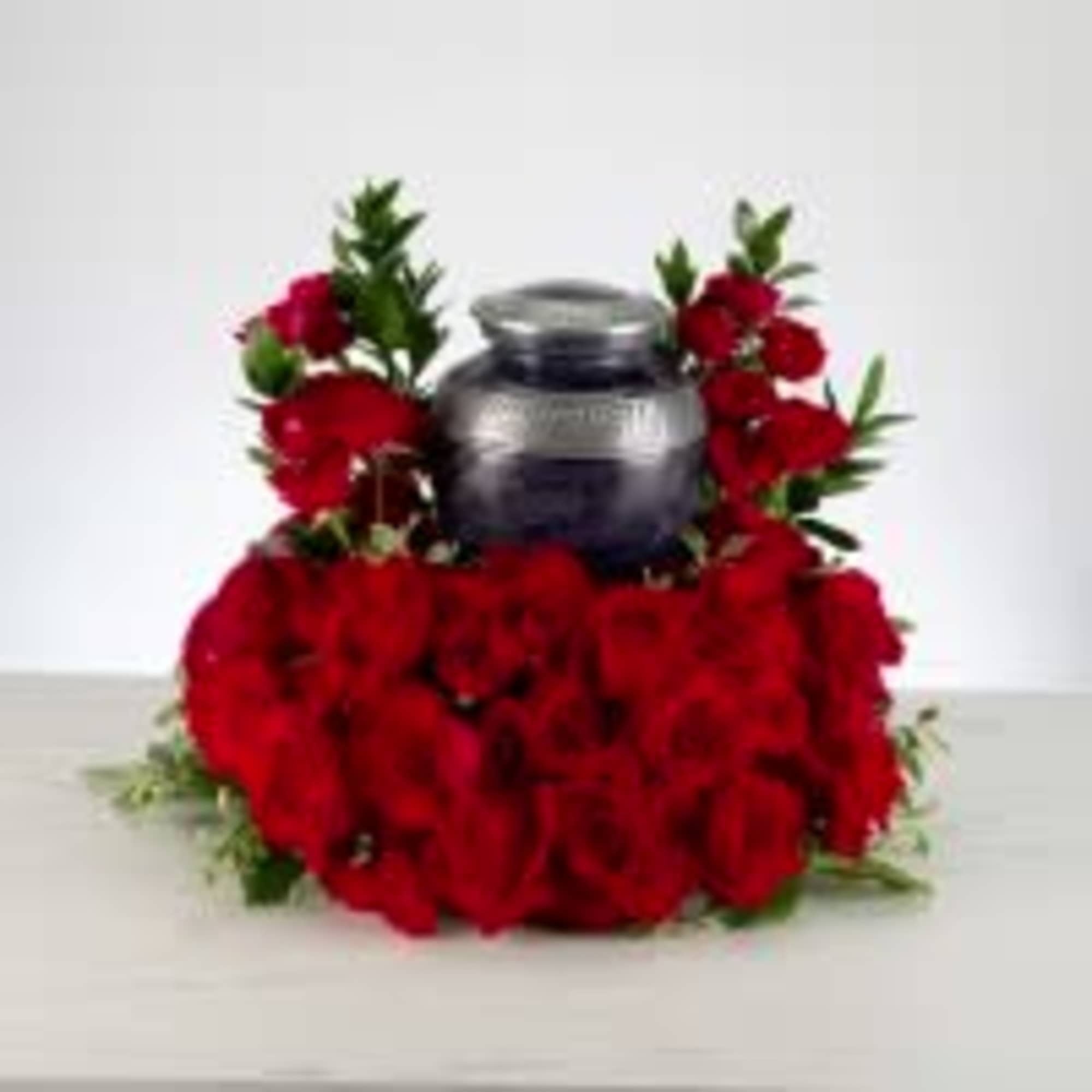 Pure red roses and greenery come together to create this beautiful urn