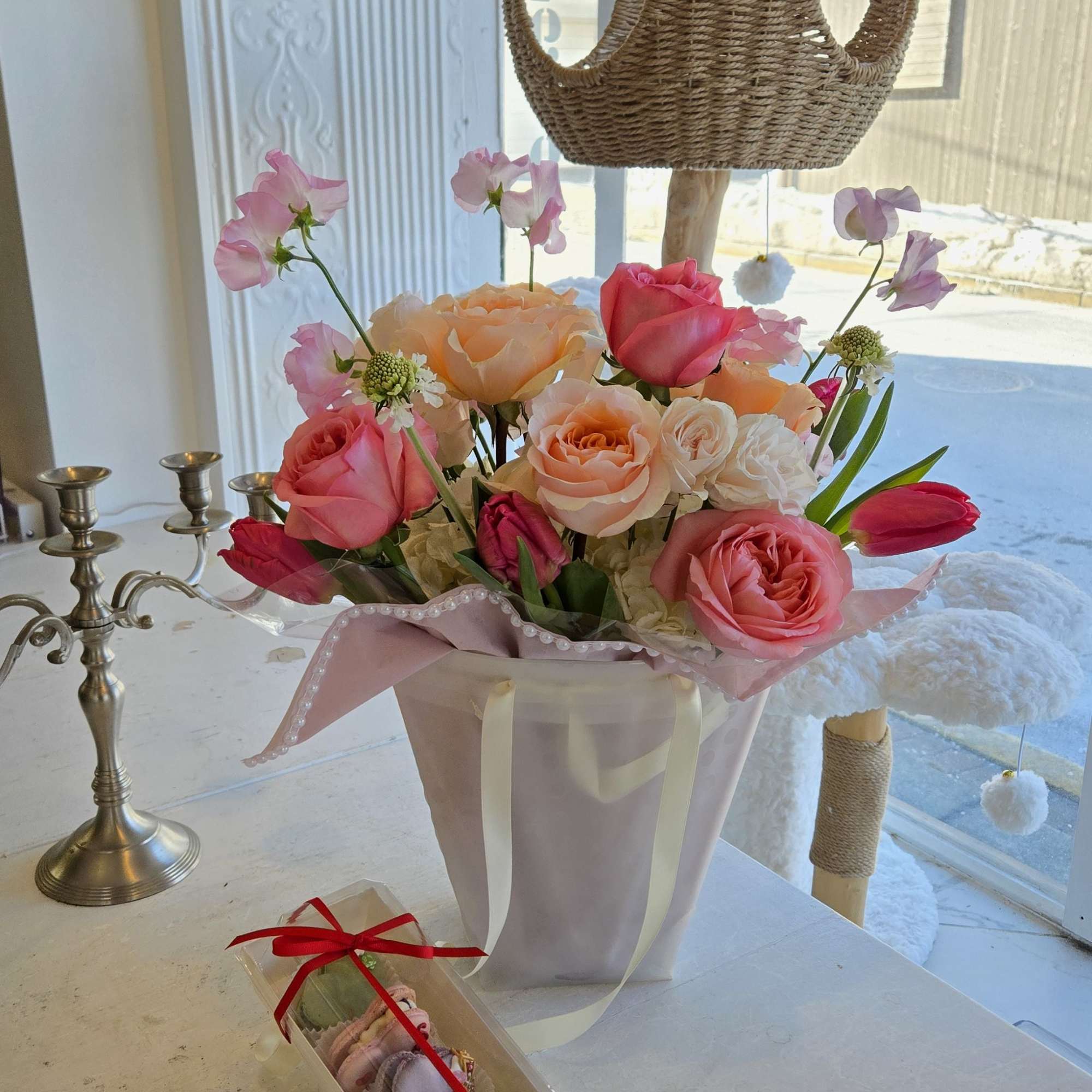 This bouquet features a lush mix of premium roses in blush, peach