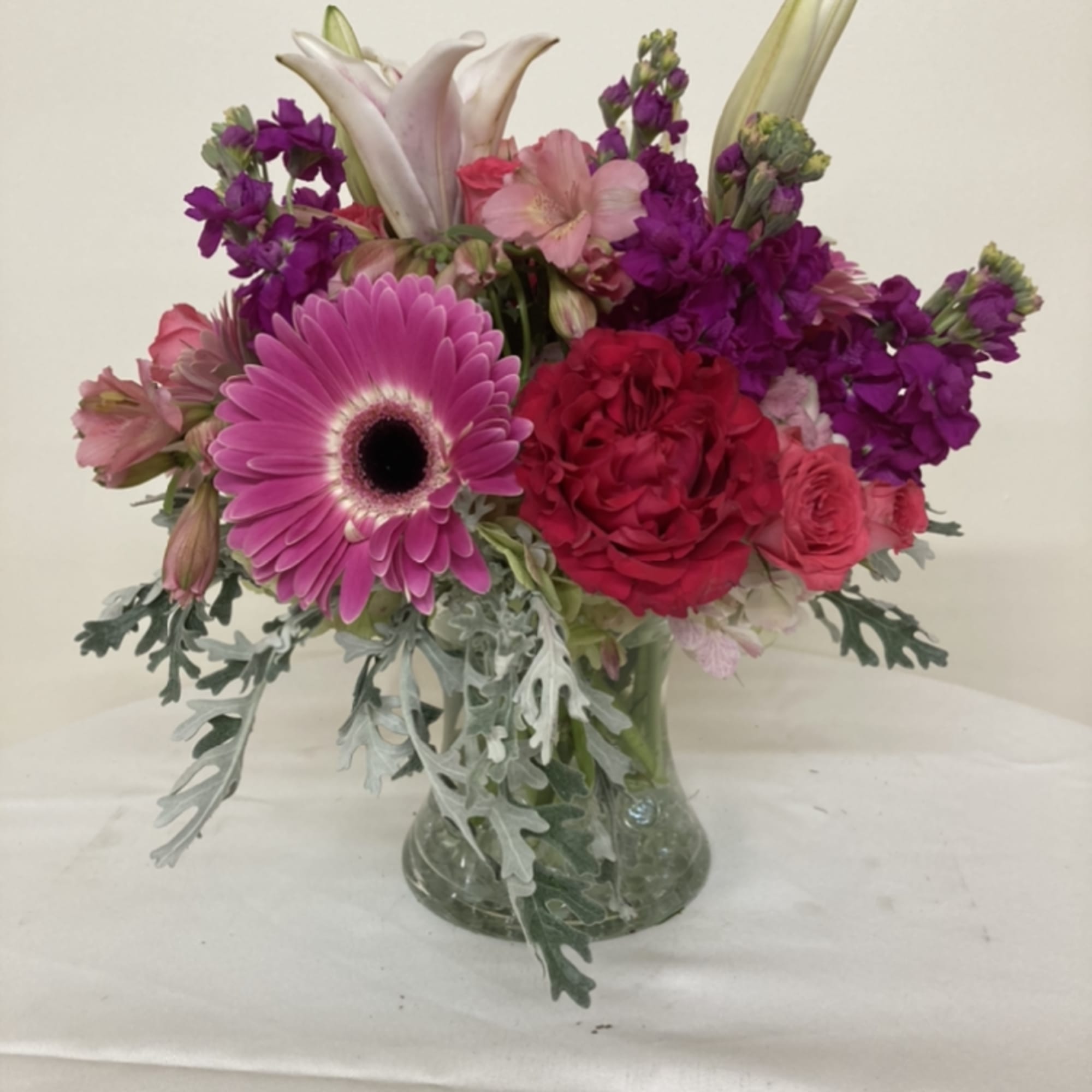 Gerber daisies, stargazer lilies. alstromeria, roses, and stock