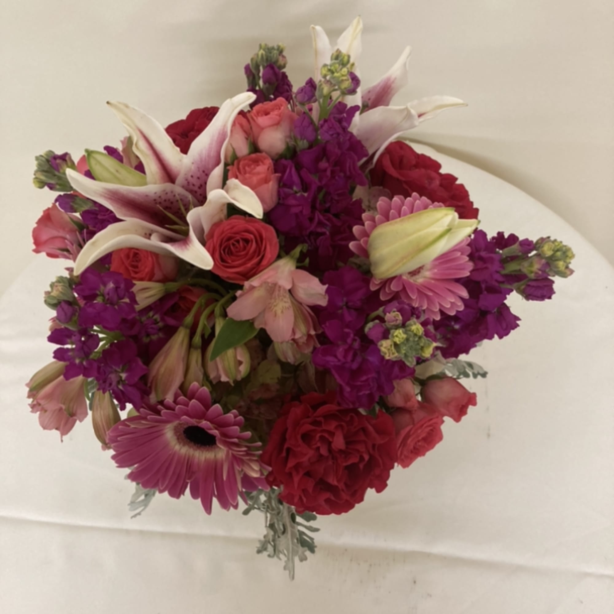 Gerber daisies, stargazer lilies. alstromeria, roses, and stock
