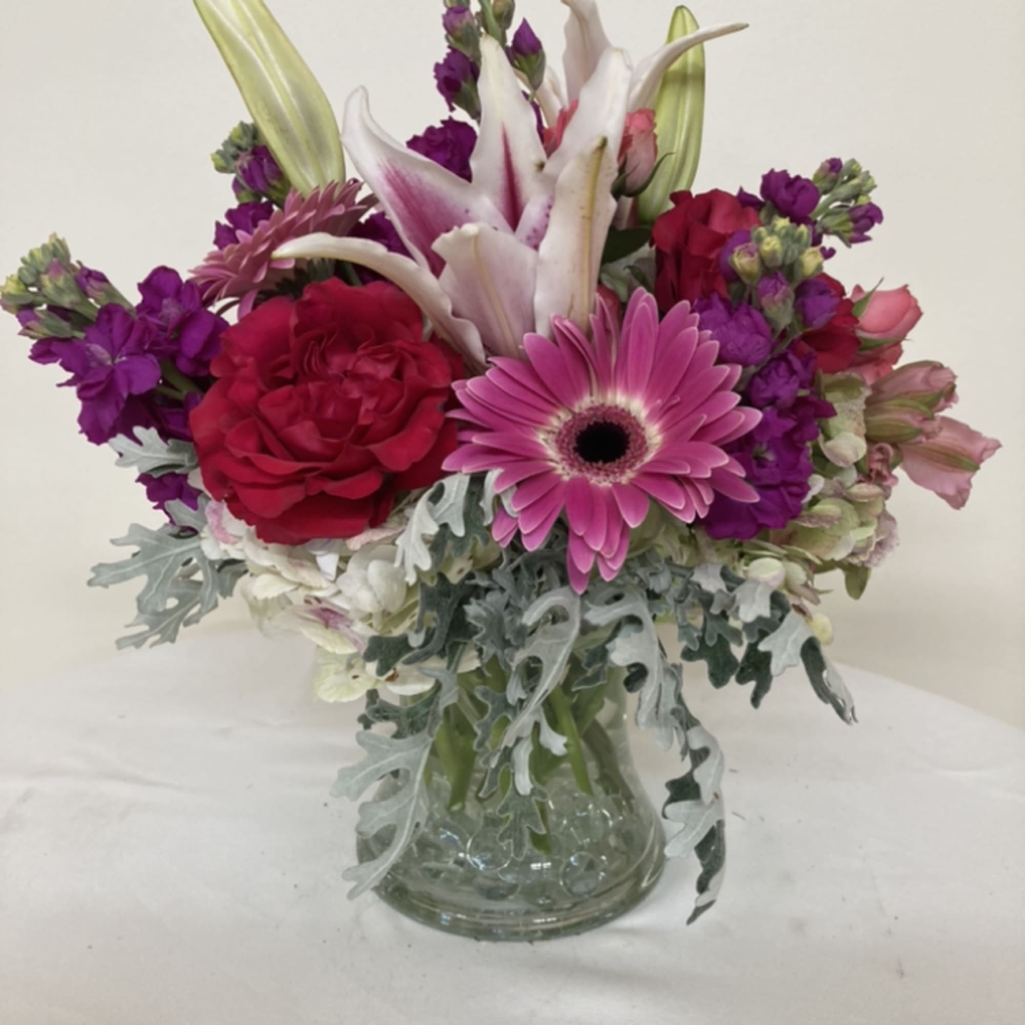 Gerber daisies, stargazer lilies. alstromeria, roses, and stock