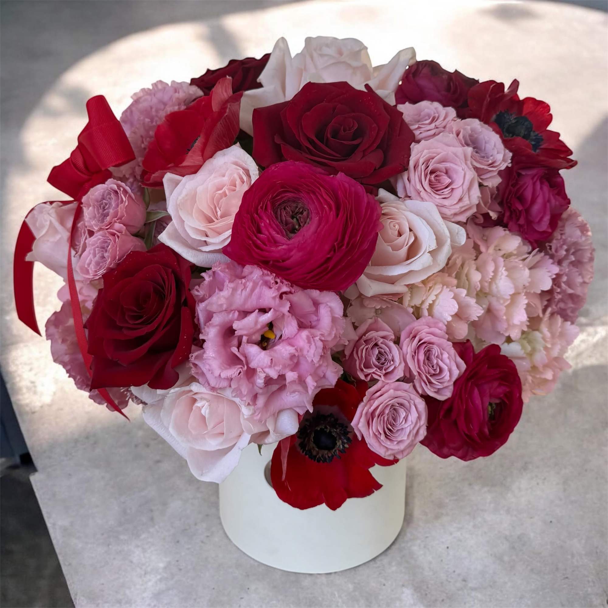 This luxury flower box showcases an elegant blend of soft pinks and