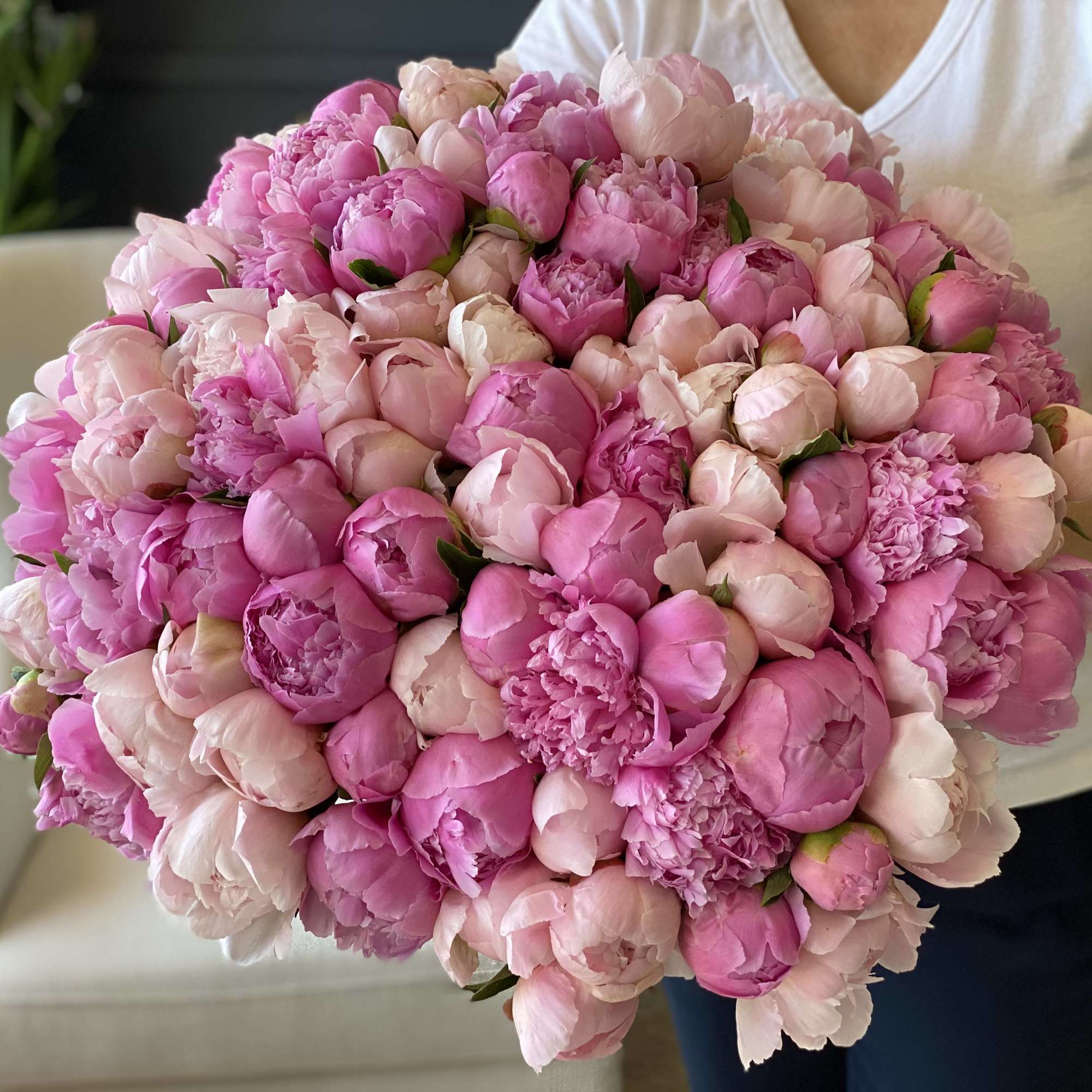Hand-crafted Bouquet with 100 stems of luxurious peonies in clear vase.