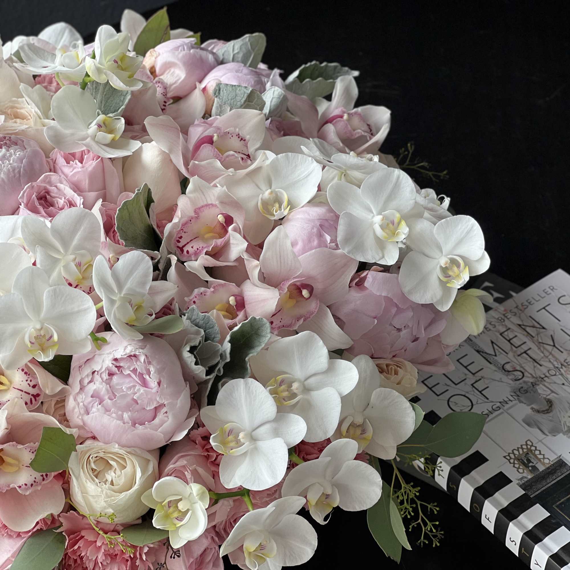 Large cement vase with mixed flowers. Large, lavish arrangement with roses, garden