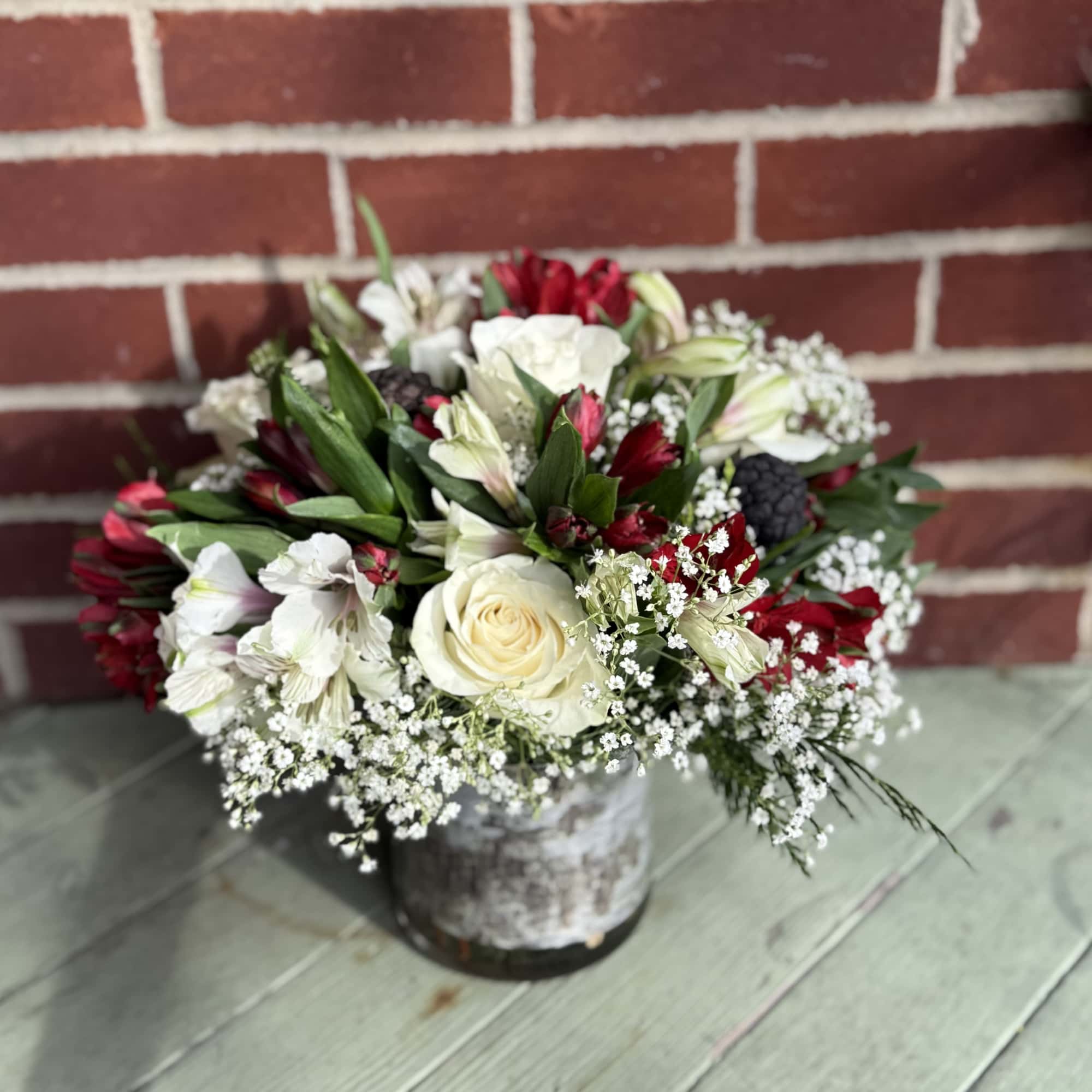 All-around arrangement with assorted greenery. Send that special someone the gift of