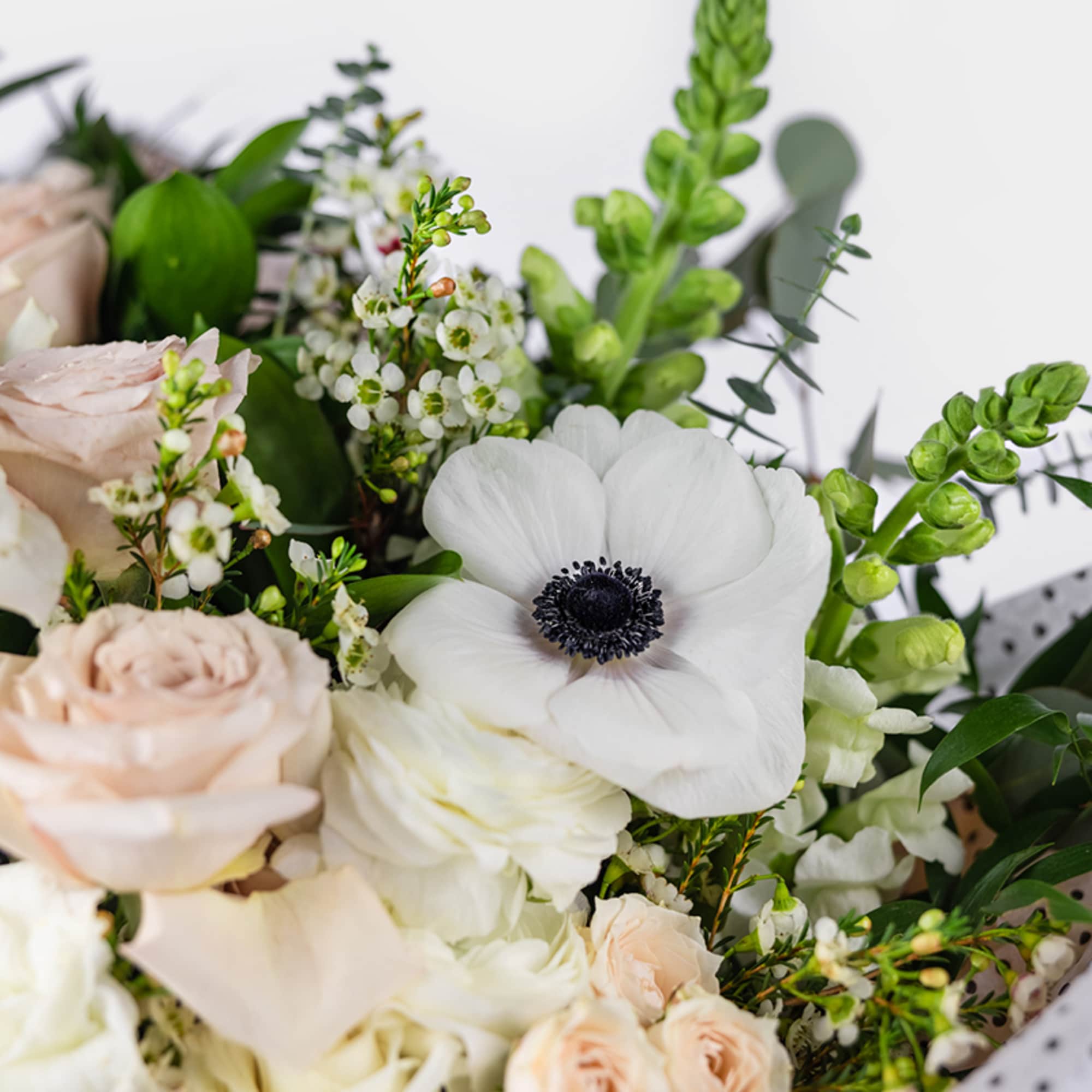 Designed in-house with a serene palette of seasonal neutral flowers. This exquisite