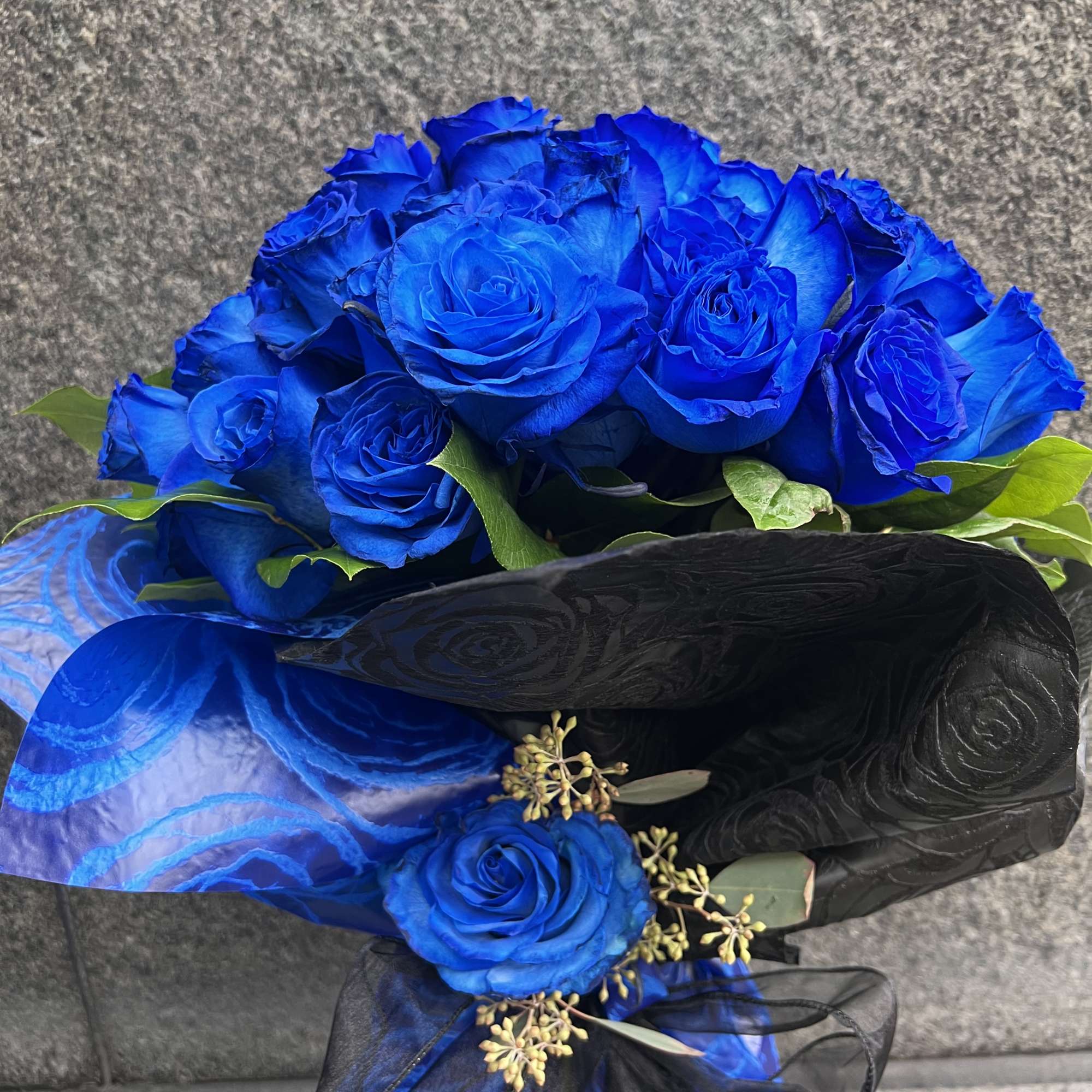 Wrapped bouquet made with 50 premium royal blue roses. It&rsquo;s a great
