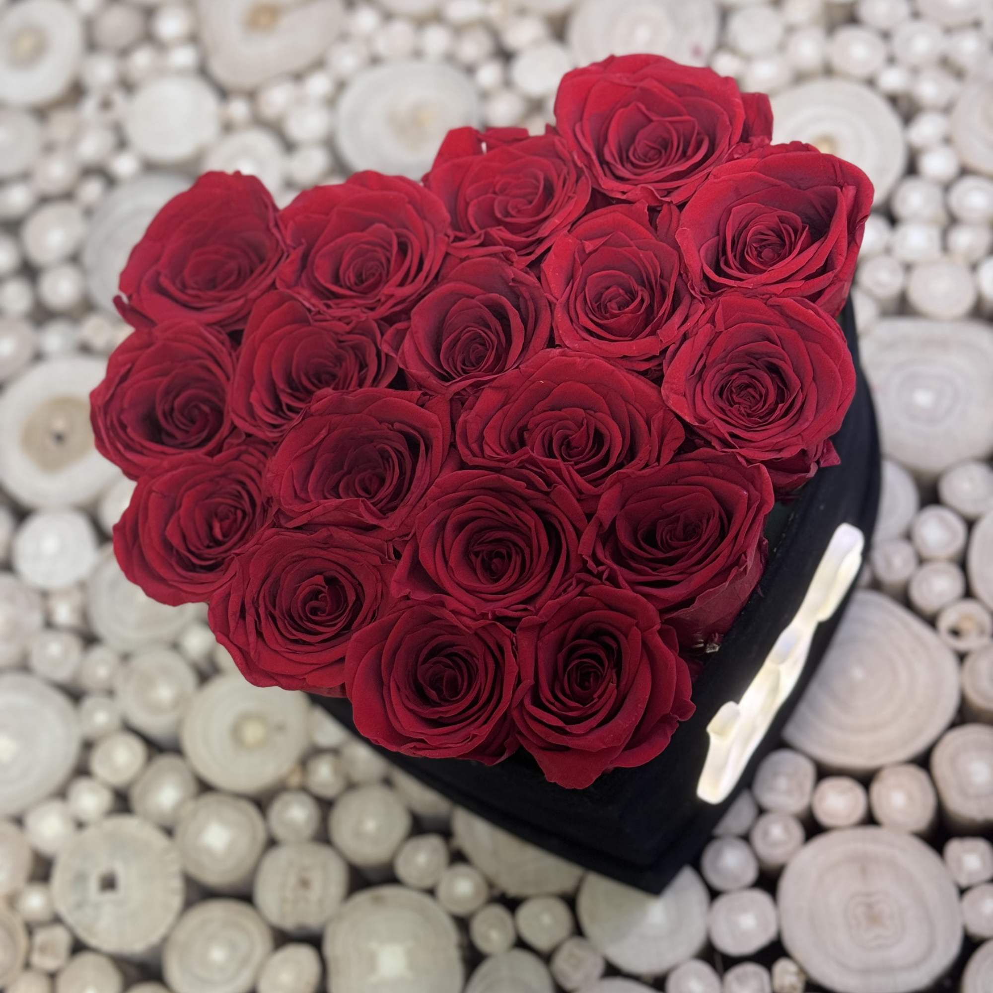 Capture hearts with  roses in a black heart-shaped velvet box. This