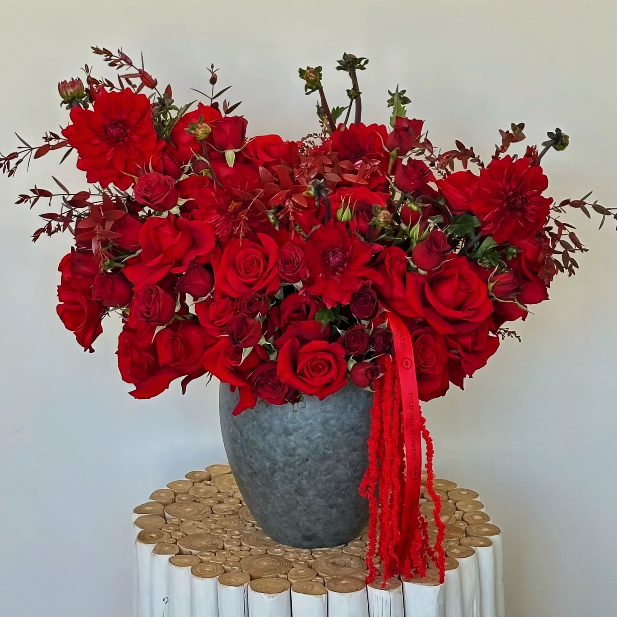 Bold and romantic, the Crimson Love Bloom arrangement is designed to impress.