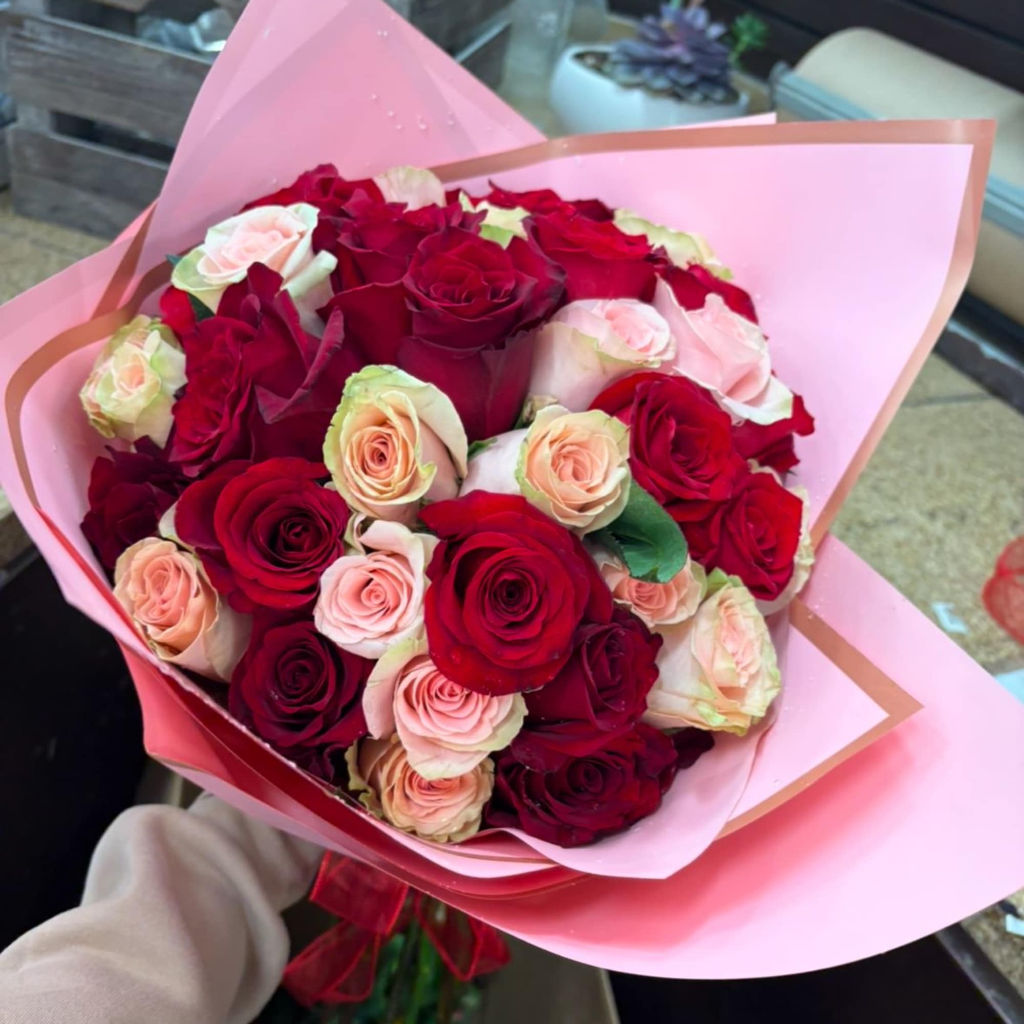 2 dozen red 2 pink roses wrapped in pink tissue with a