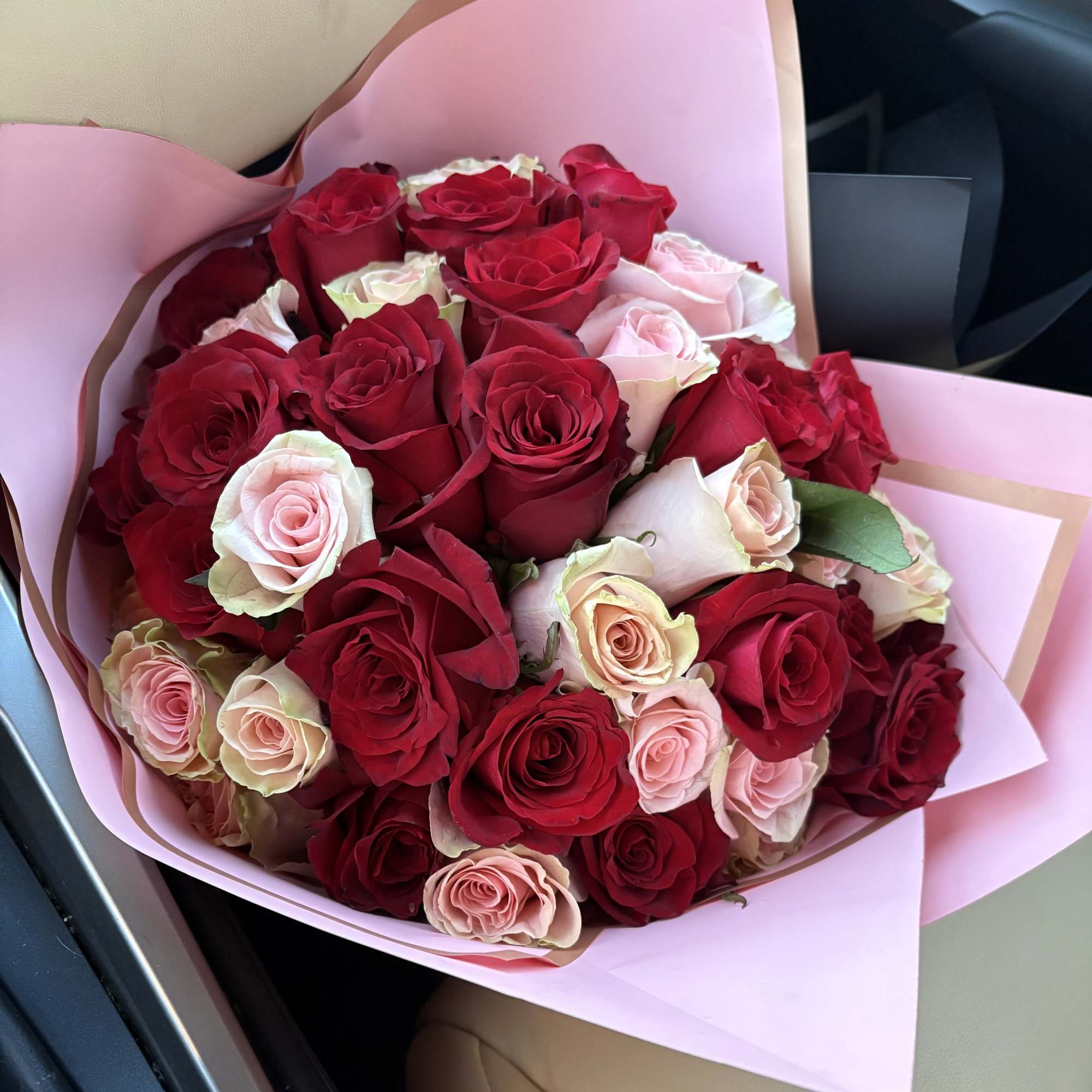 2 dozen red 2 pink roses wrapped in pink tissue with a