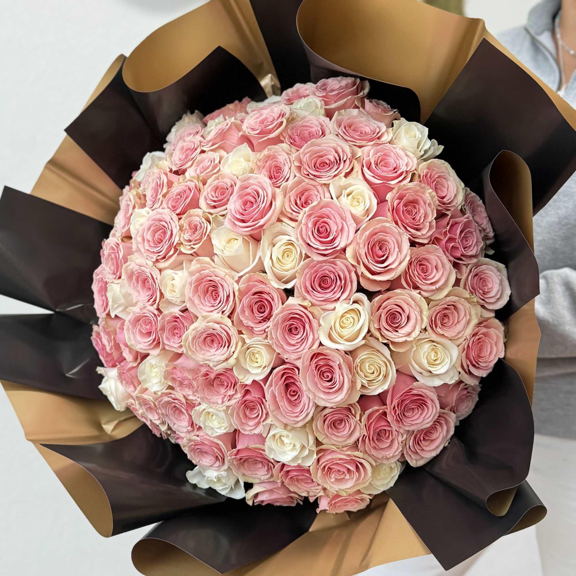 100 long-stem pink and white roses with decorative wrapping paper. One hundred
