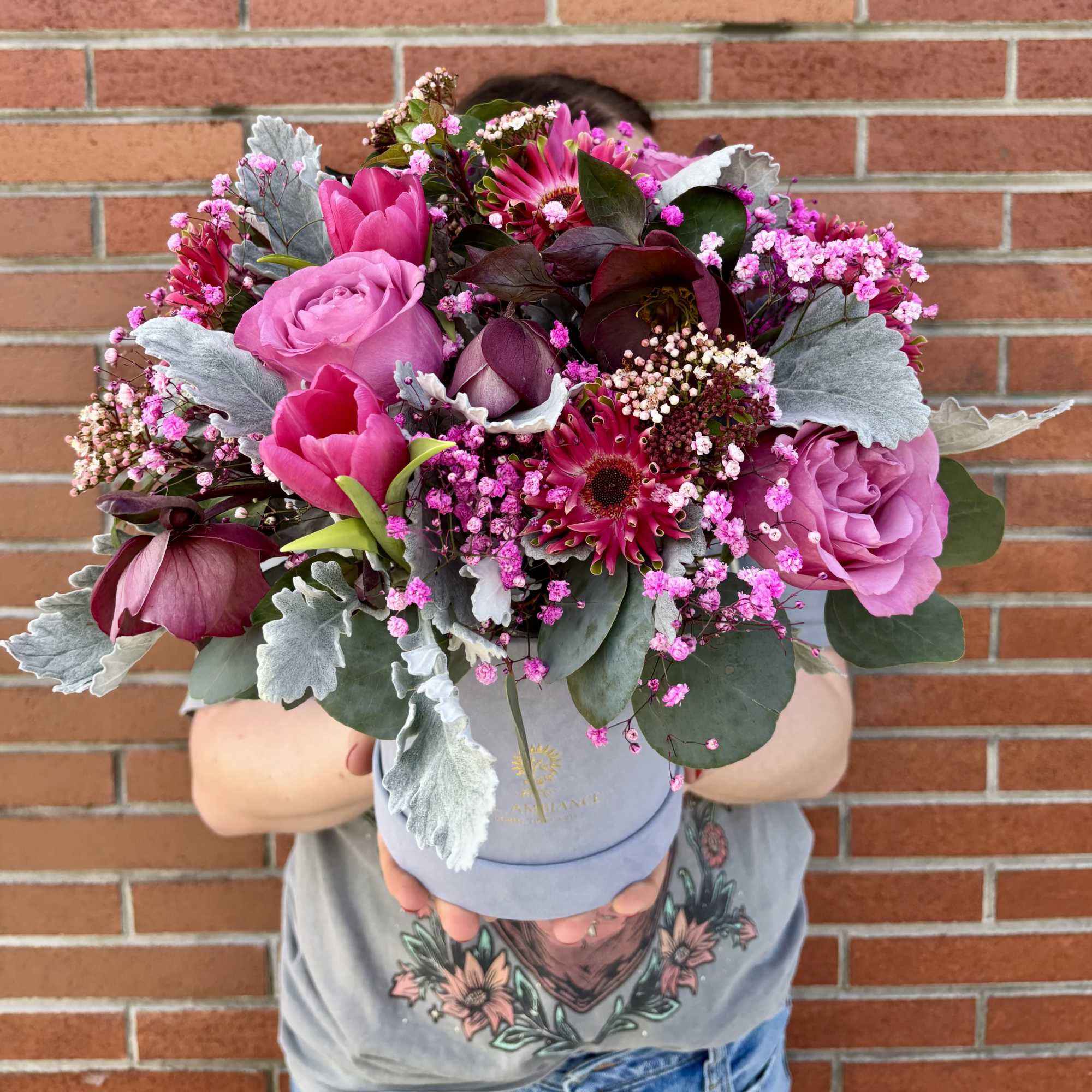 Vibrant and fragrant lavender roses, expertly designed with tulip, hellebore, and baby's