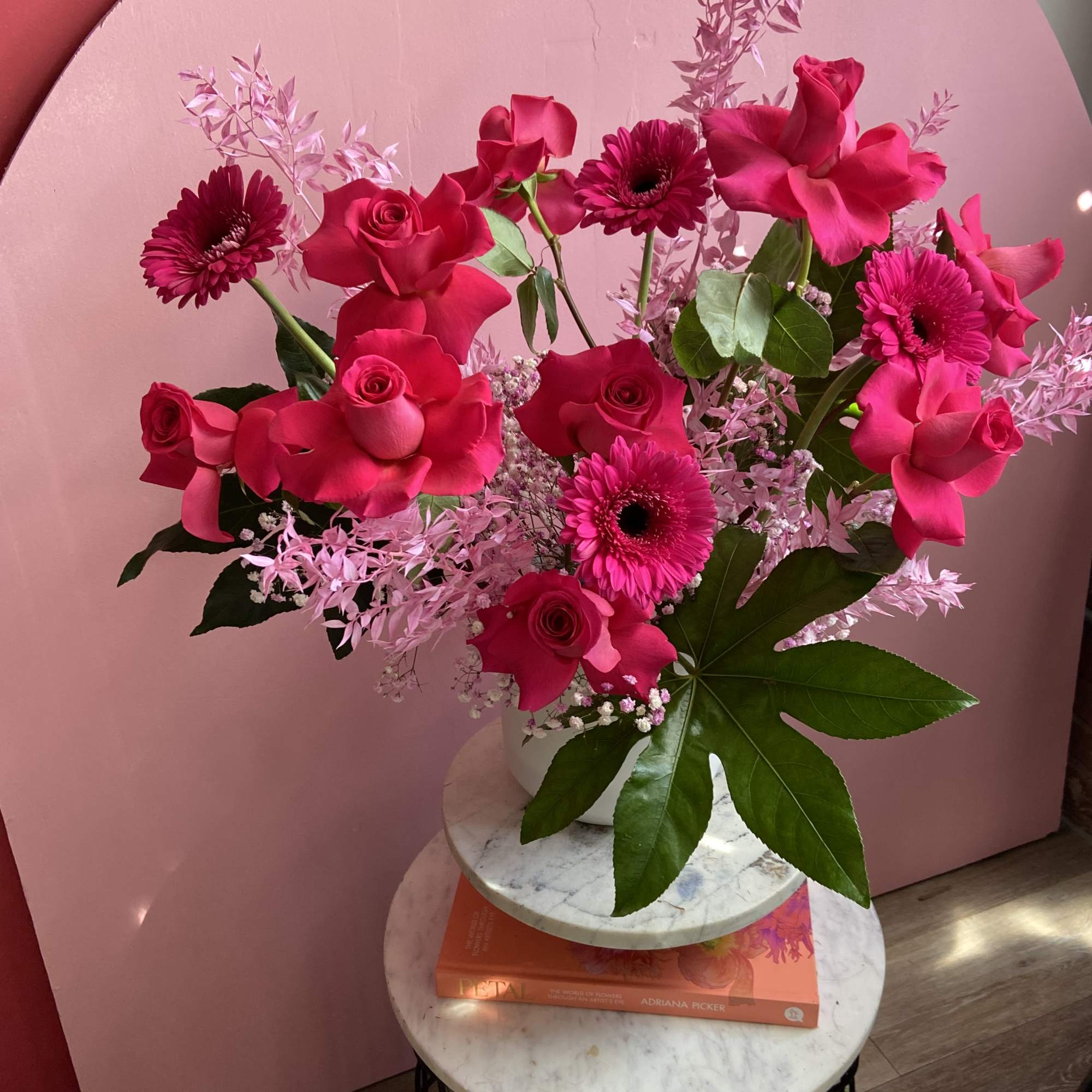 Pink Monochromatic statement piece bursting with Pink Floyd roses, Gerber daisies, and