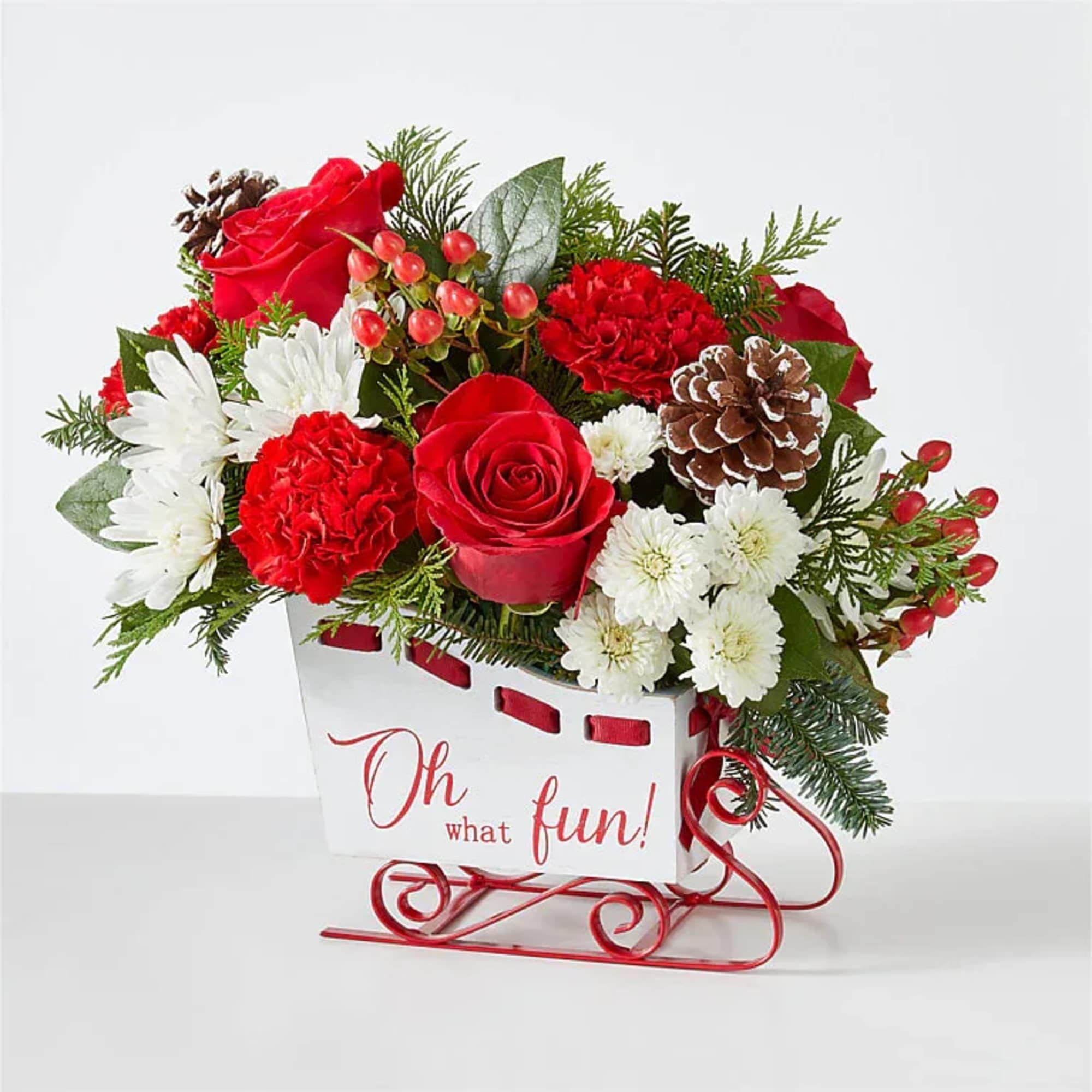 Sled into the holiday season with this lush arrangement of red roses