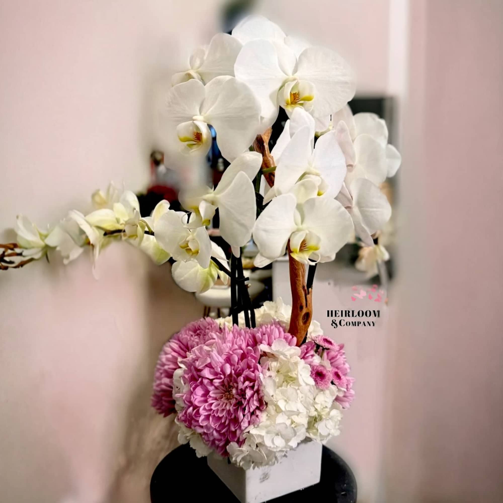 Graceful, timeless, and quietly luxurious &mdash; this sculptural orchid arrangement is designed