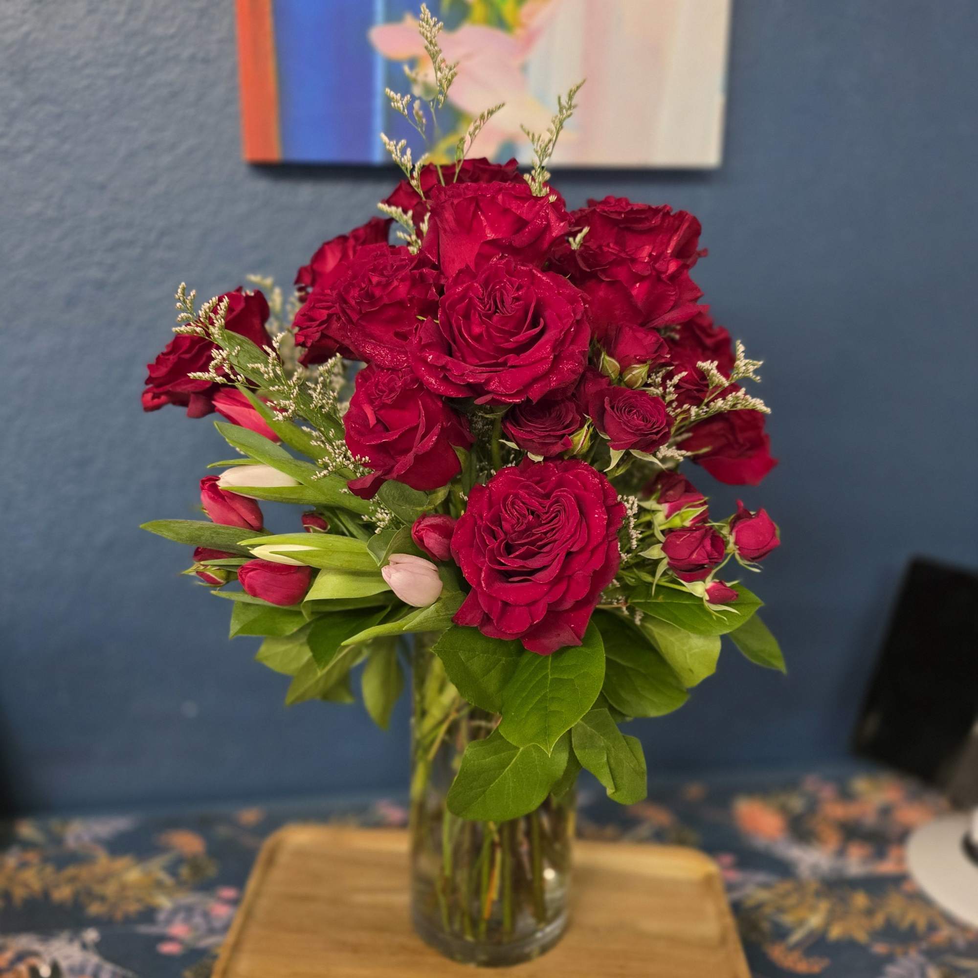 Red roses, tulips, spray roses and filler.  Send love and kisses