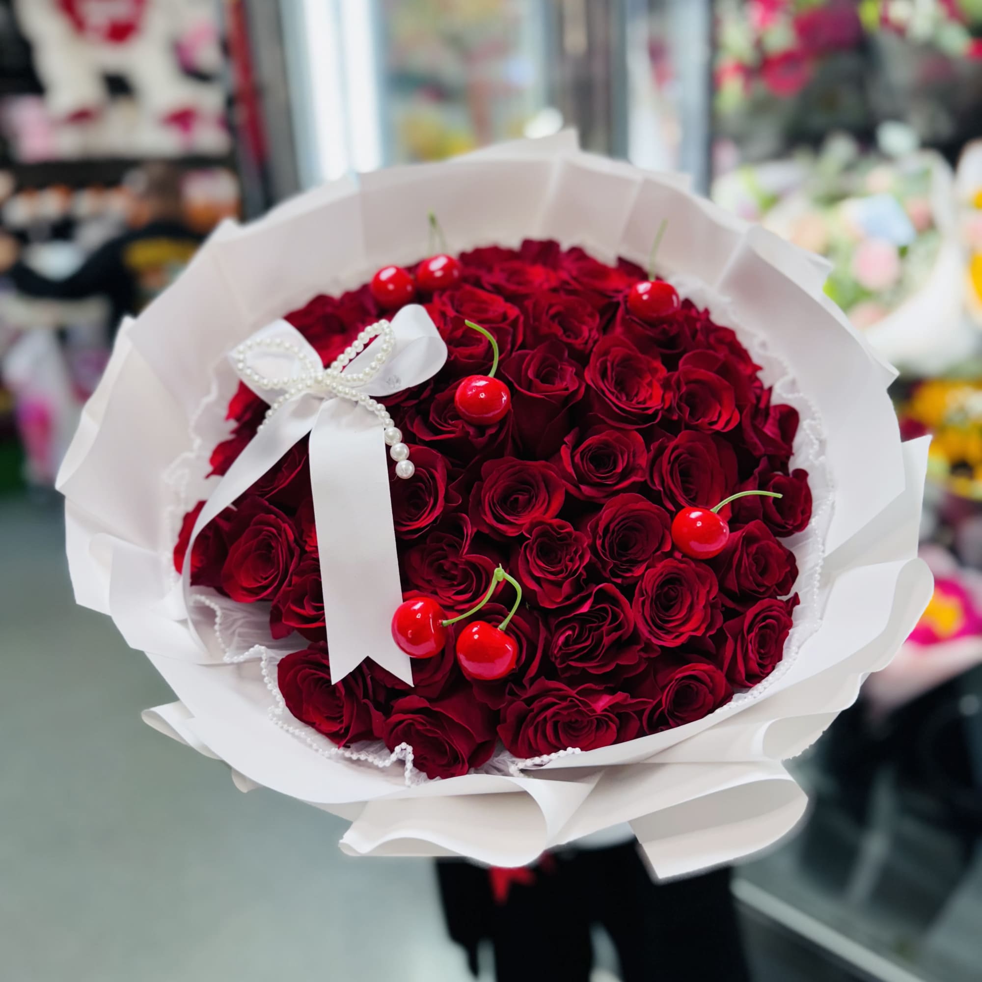 White Wrapping paper 50 Roses.
Plastic Cherries 
White Bow to finish it off!