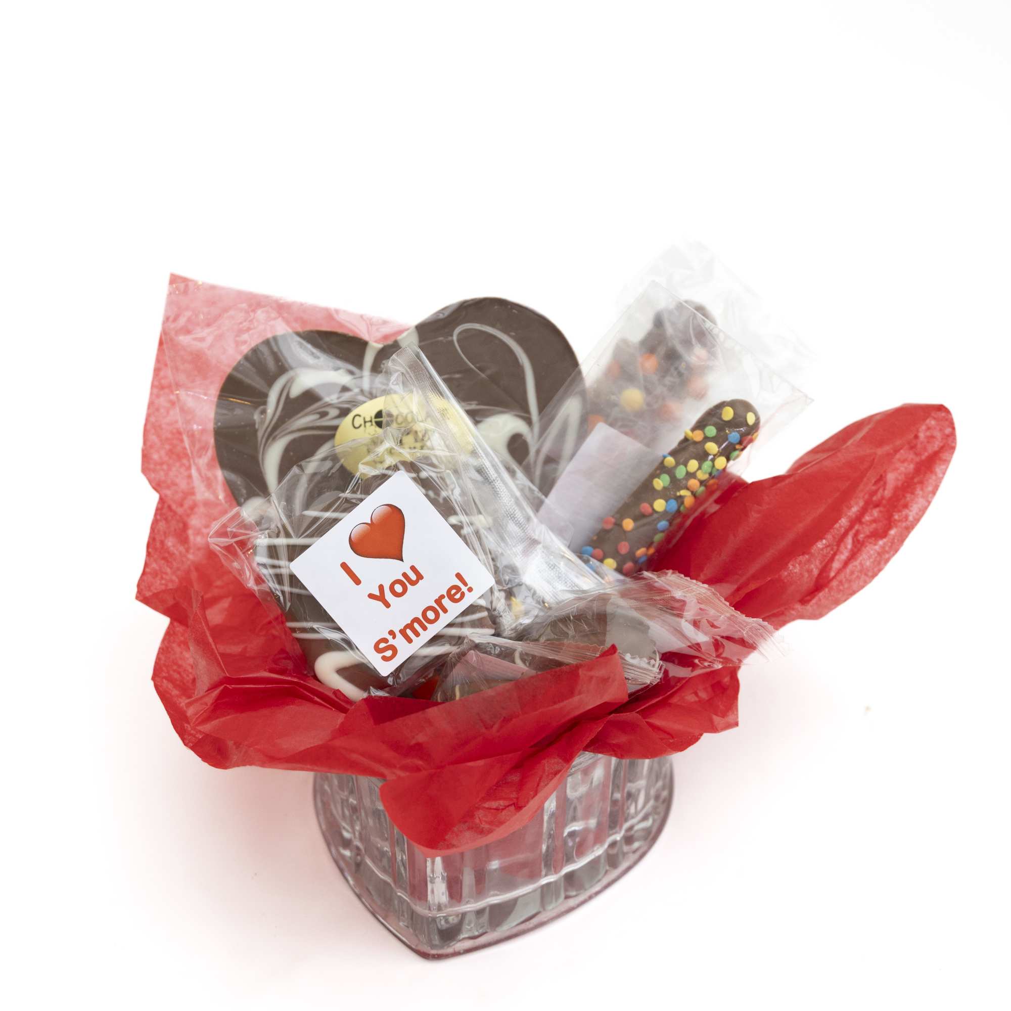 A low heart shaped glass vase filled with Chocolate Pizza Company chocolate