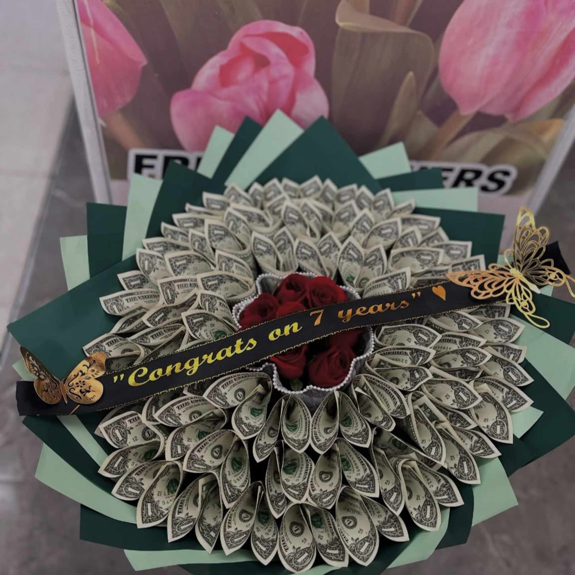 The standard size contains 7 roses and $50 in $1 bills .