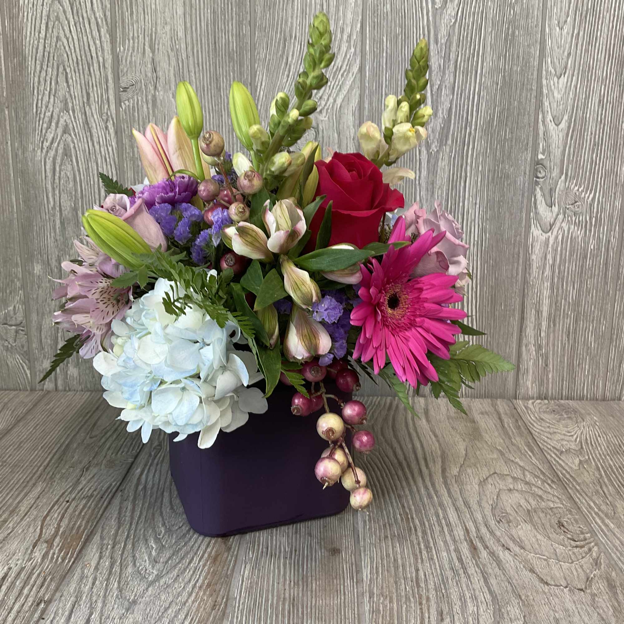 A wonderful assortment of berry colored flowers.