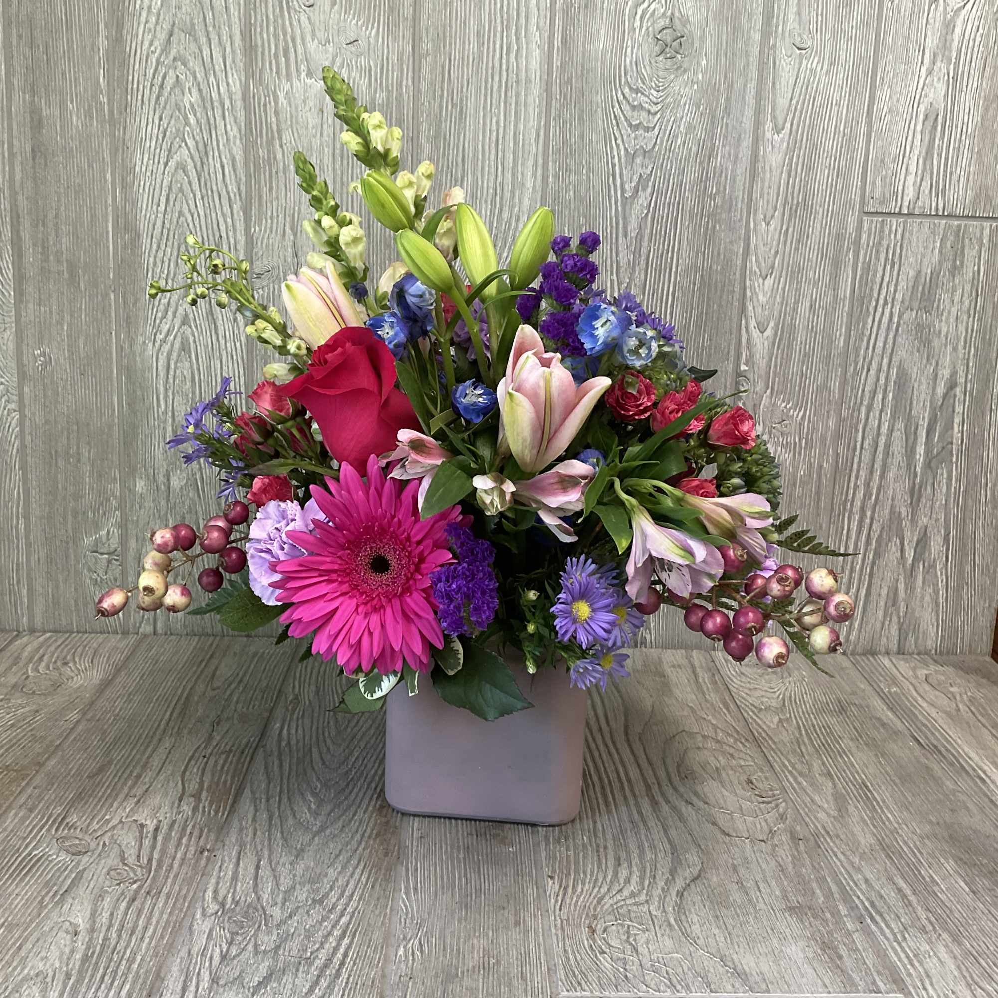 A wonderful assortment of berry colored flowers.