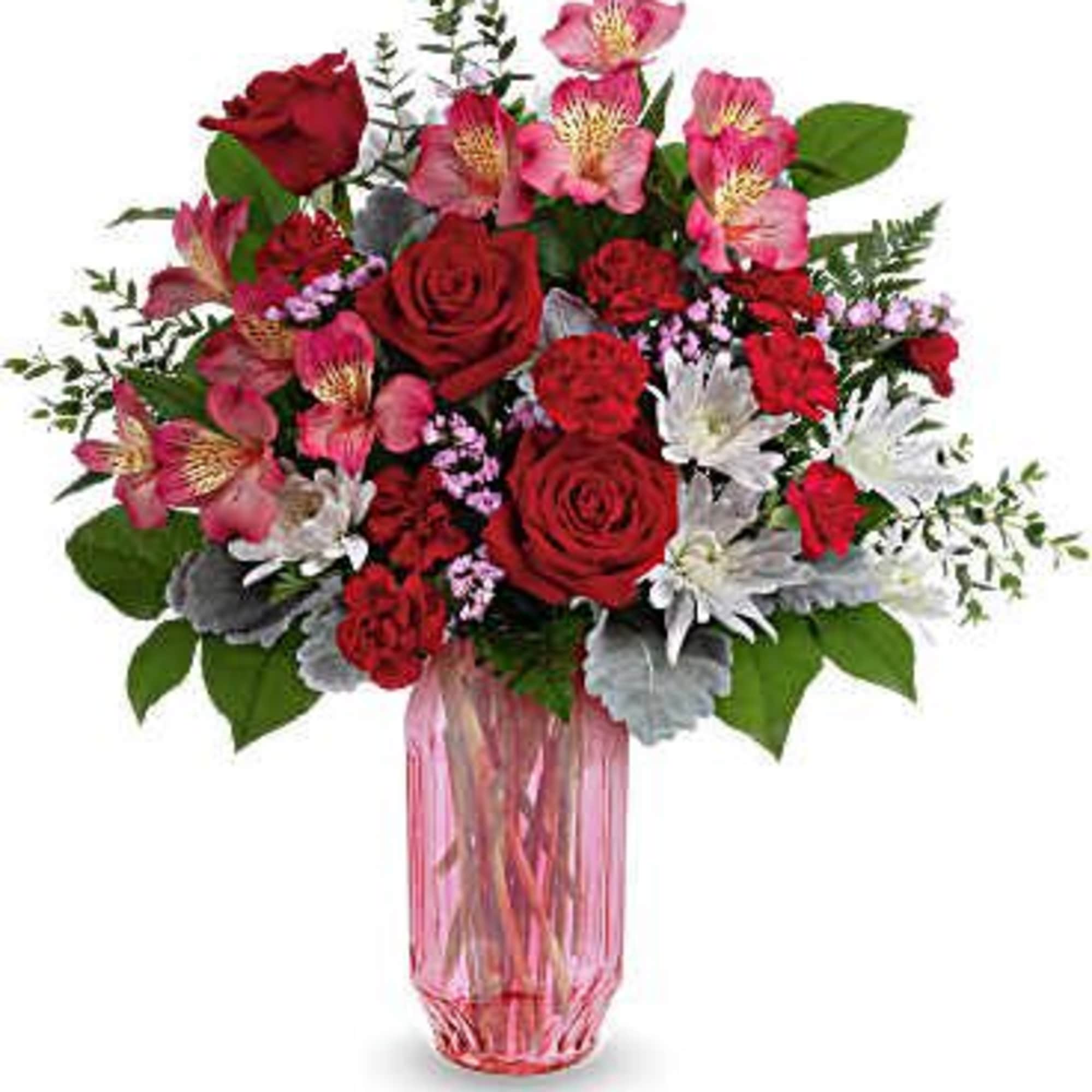 A gorgeous gem keepsake pink vase filled with an assortment of roses