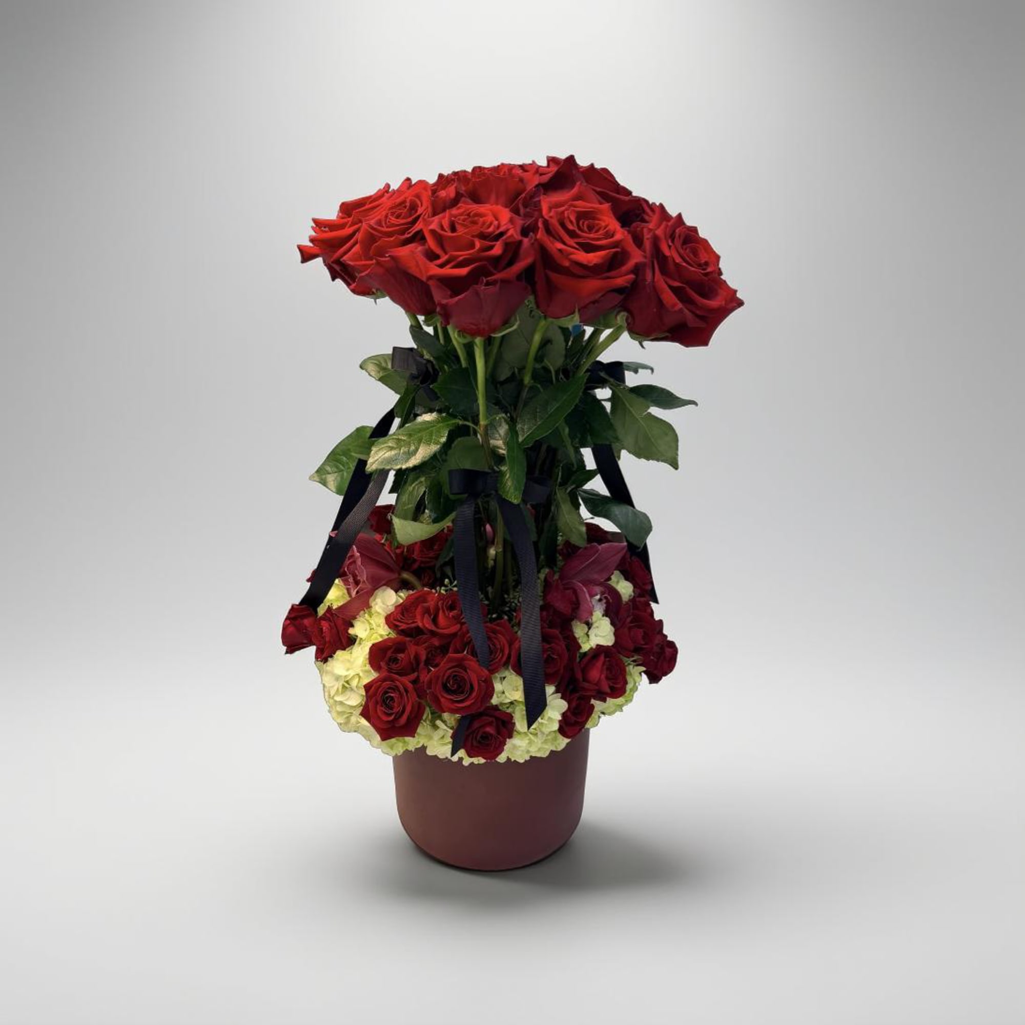 This is a luxurious and grand floral arrangement presented in a stylish