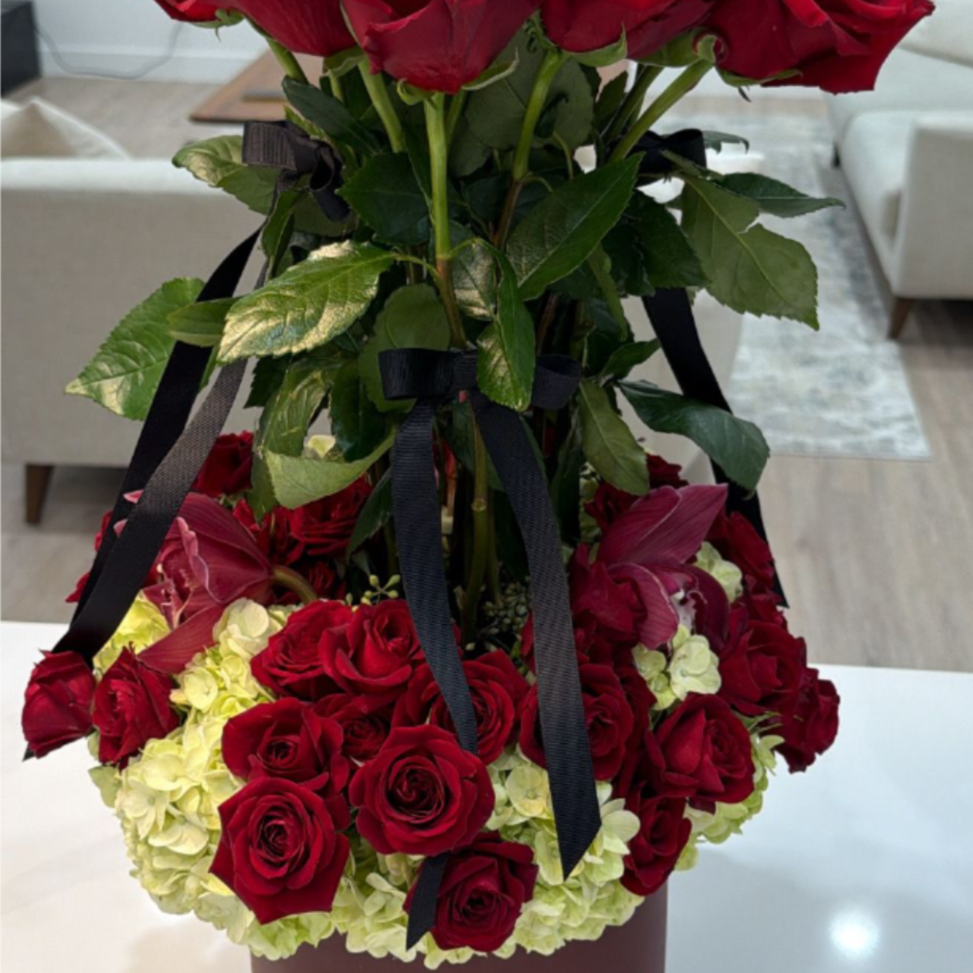 This is a luxurious and grand floral arrangement presented in a stylish