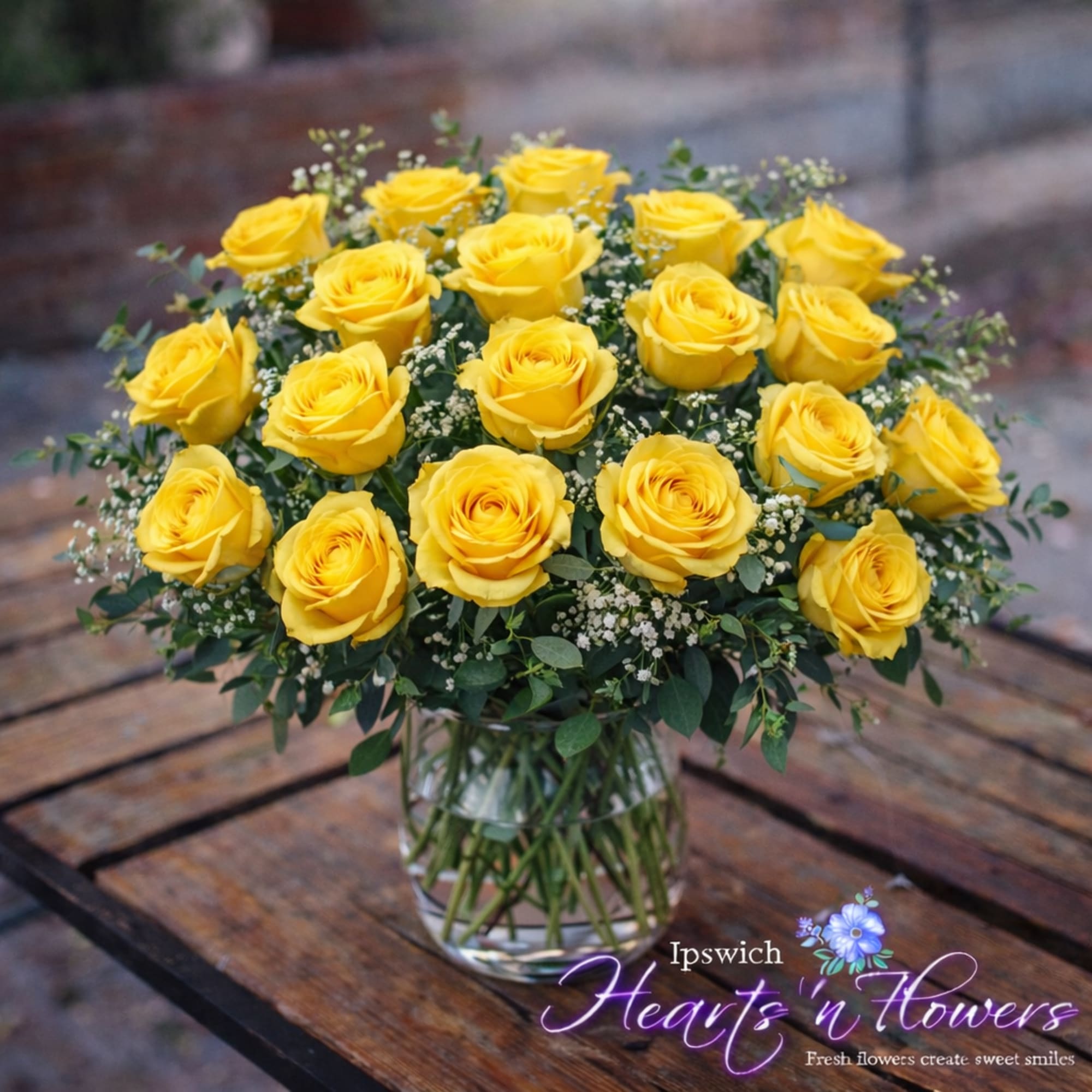 This stunning arrangement features two dozen vibrant yellow roses, artfully designed in