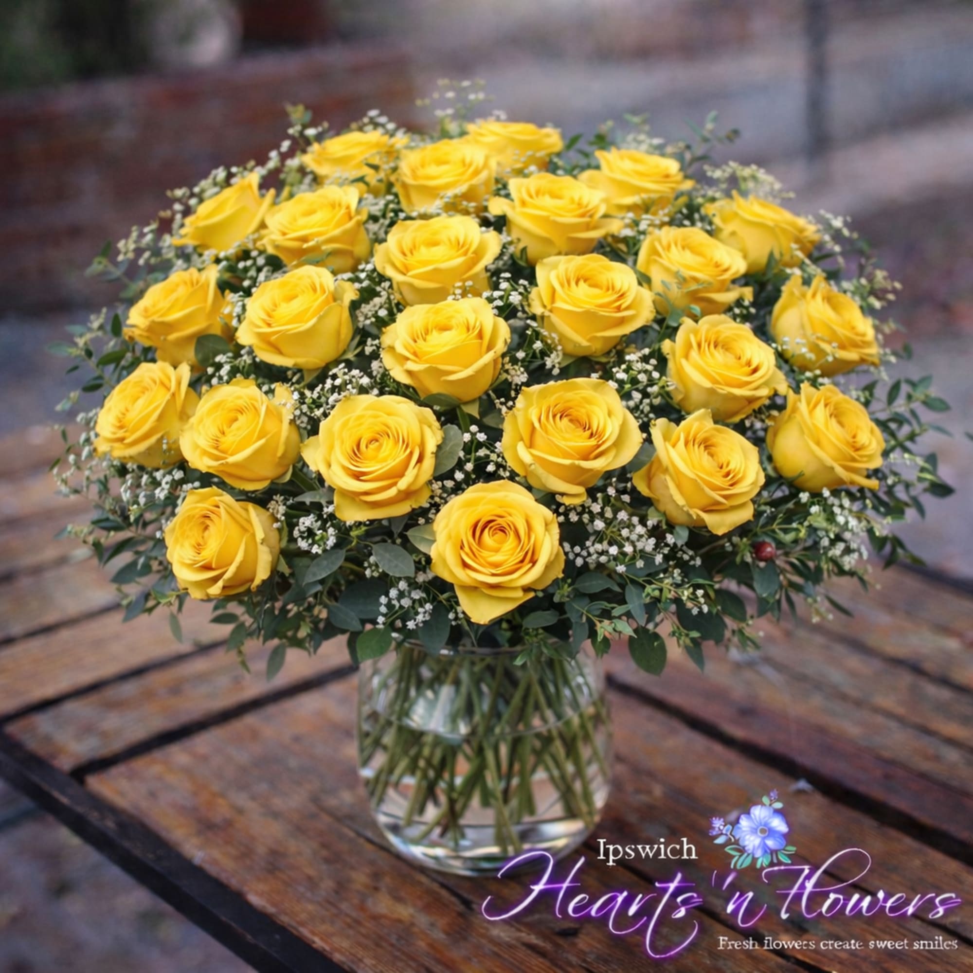 This stunning arrangement features two dozen vibrant yellow roses, artfully designed in