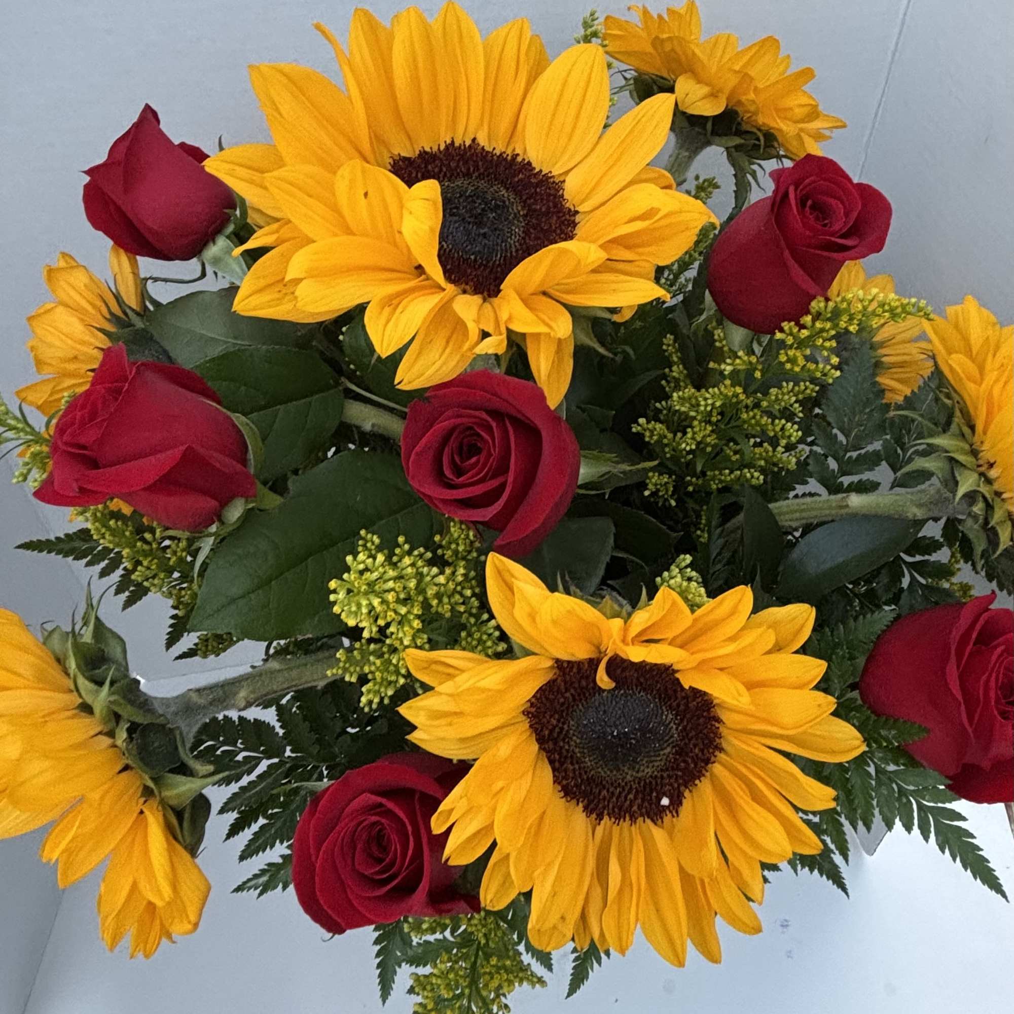 Red roses and sunflowers are a classic combination that makes everyone smile!