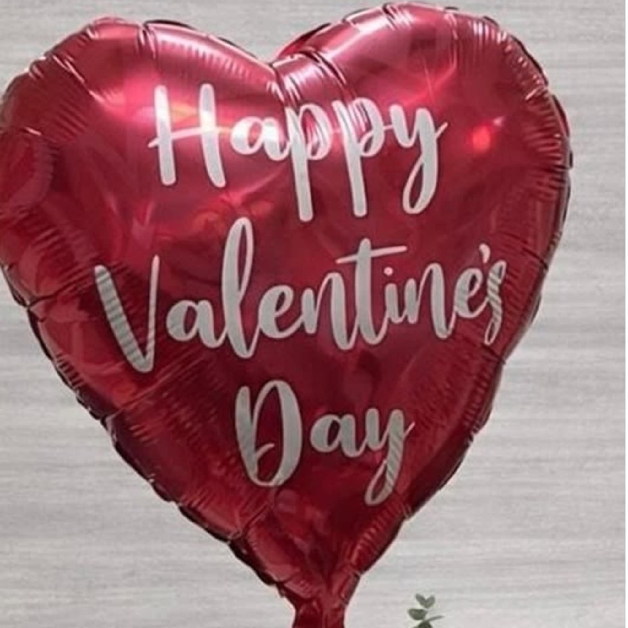 This charming Valentine&rsquo;s arrangement showcases vibrant red roses with faux diamonds, 