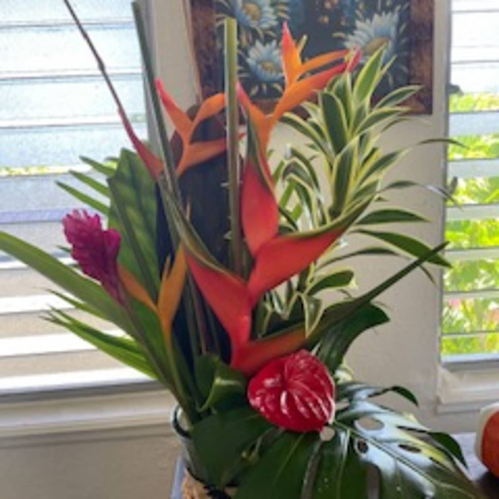 levate your space with our Tropical Arrangement, featuring an assortment of vibrant