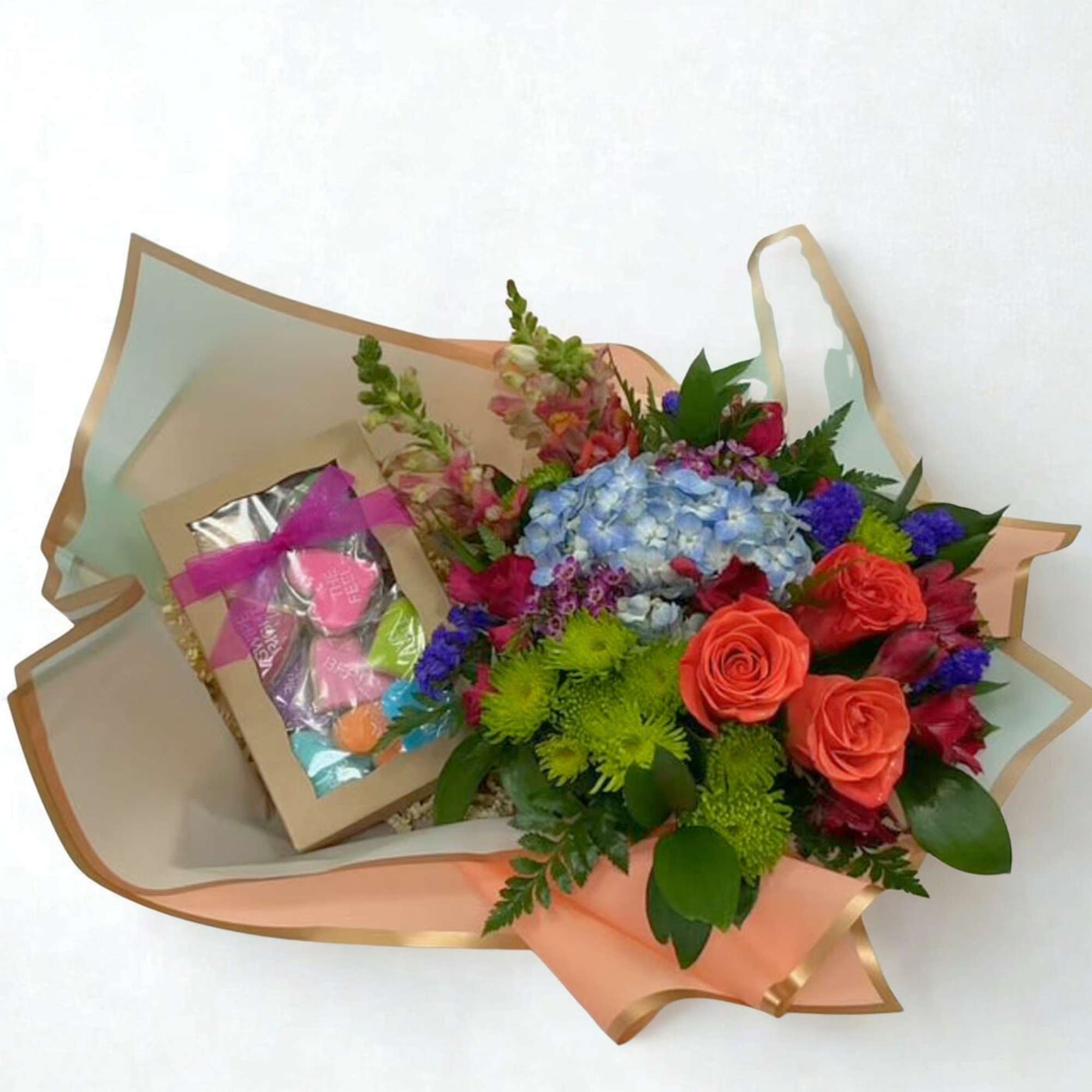 A cheerful, low-profile arrangement bursting with bright, colorful blooms, beautifully paired with
