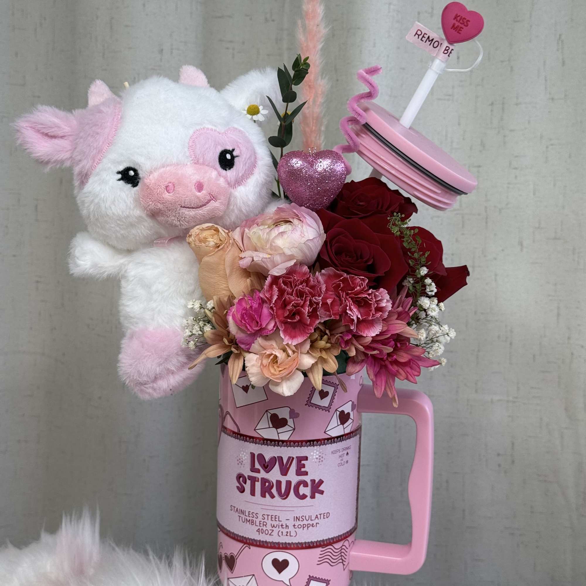 A sweet and charming floral arrangement presented in a modern, reusable &ldquo;Love