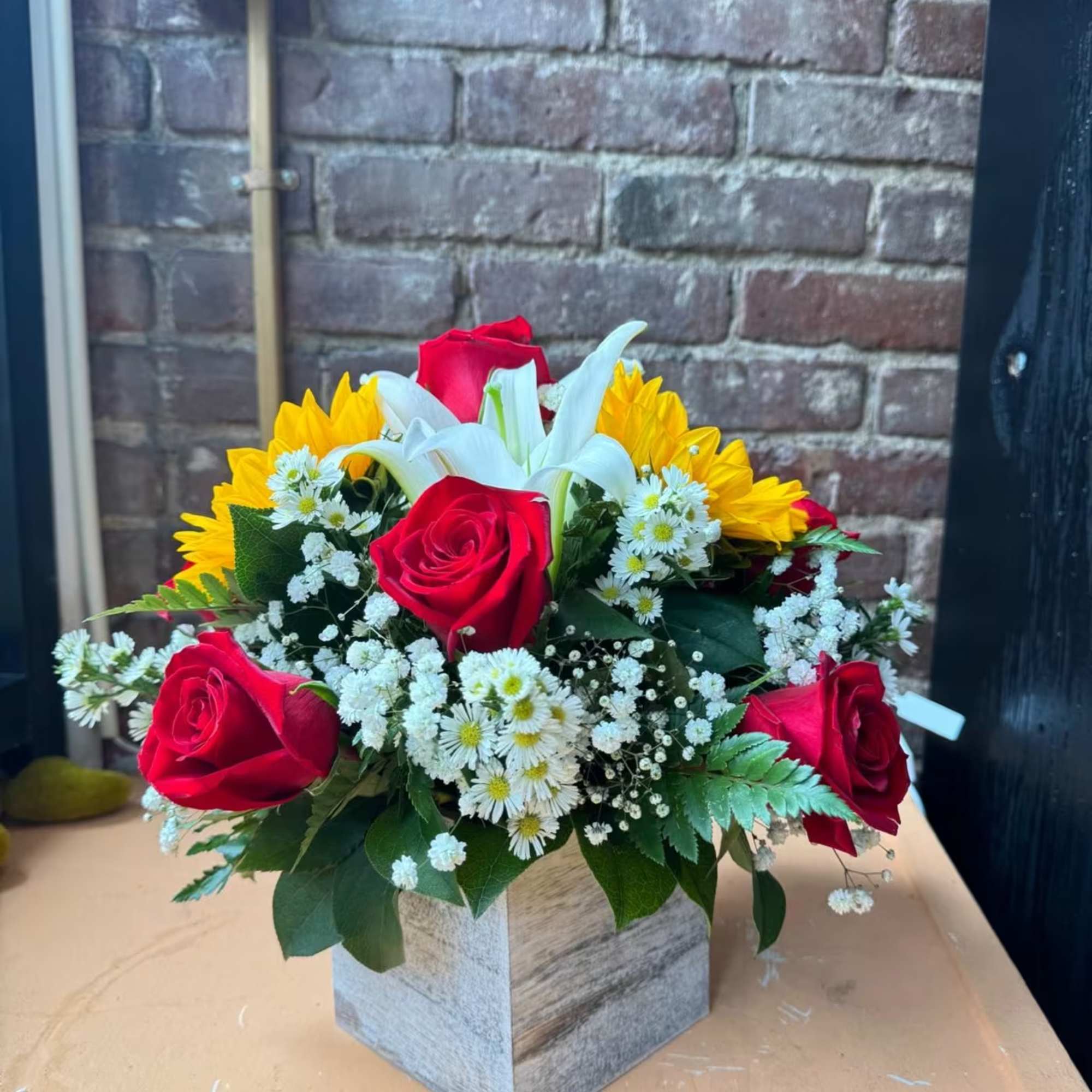 Elegant arrangement for all occasions contains 9 red roses with lilies and