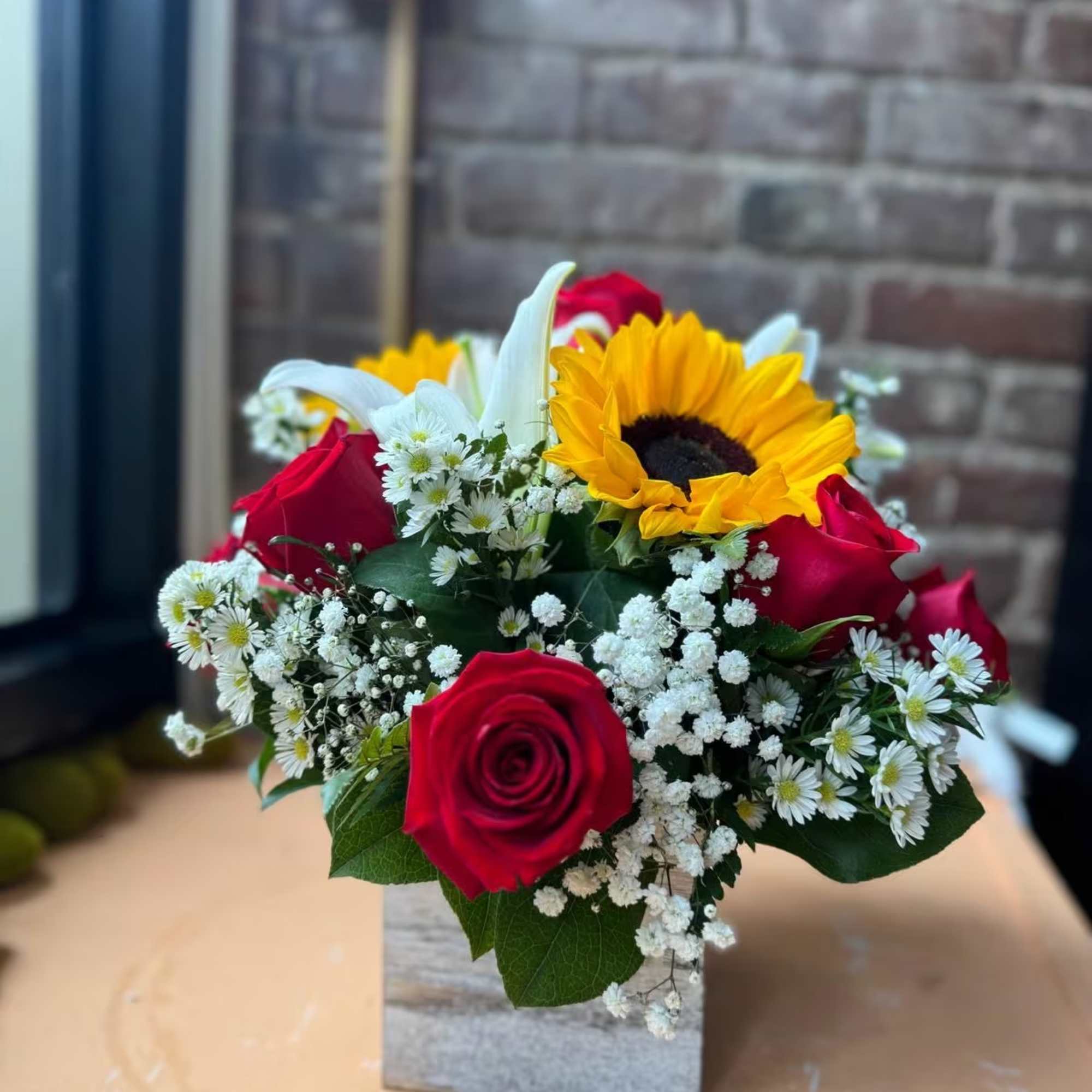 Elegant arrangement for all occasions contains 9 red roses with lilies and