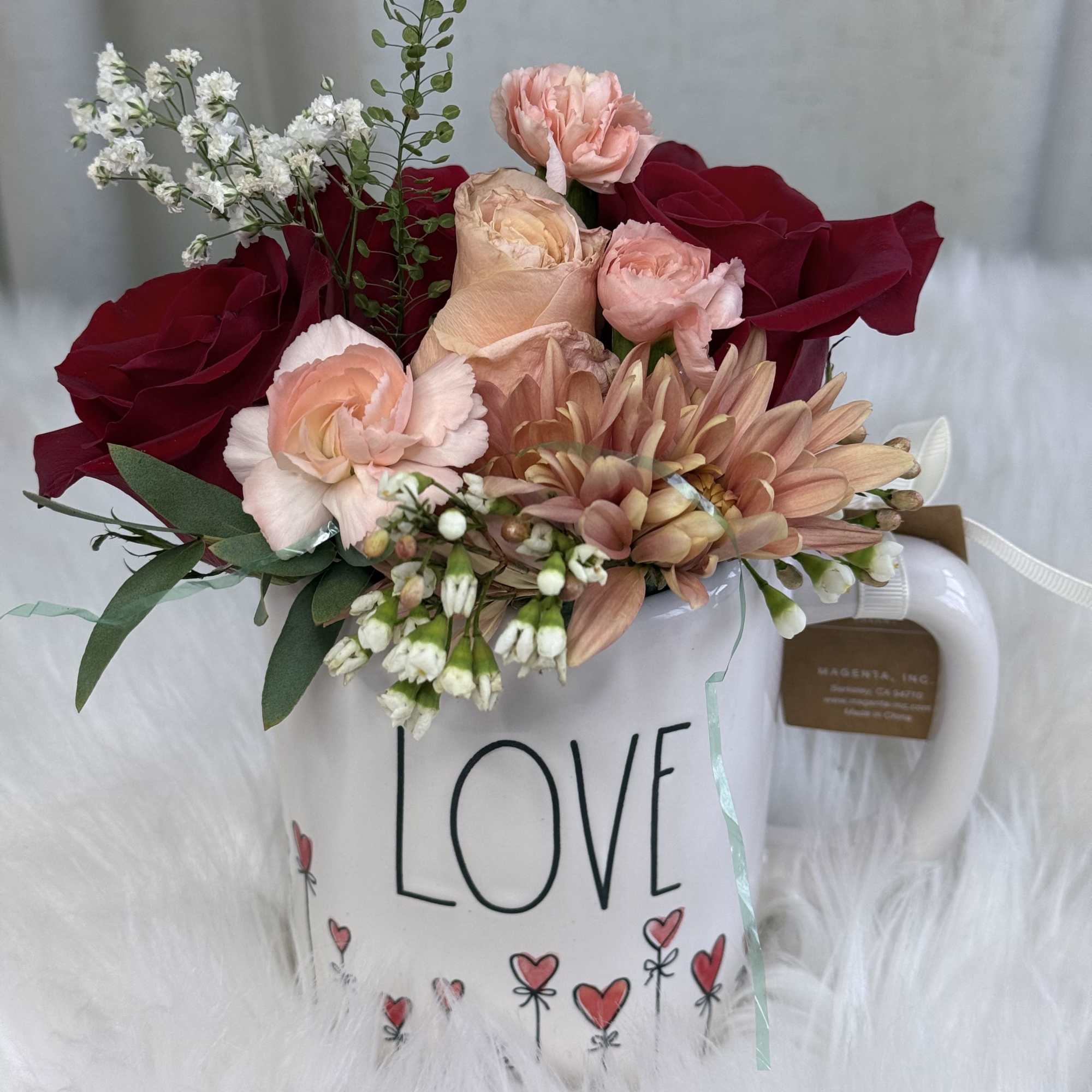  A romantic and delicate floral arrangement presented in a charming LOVE