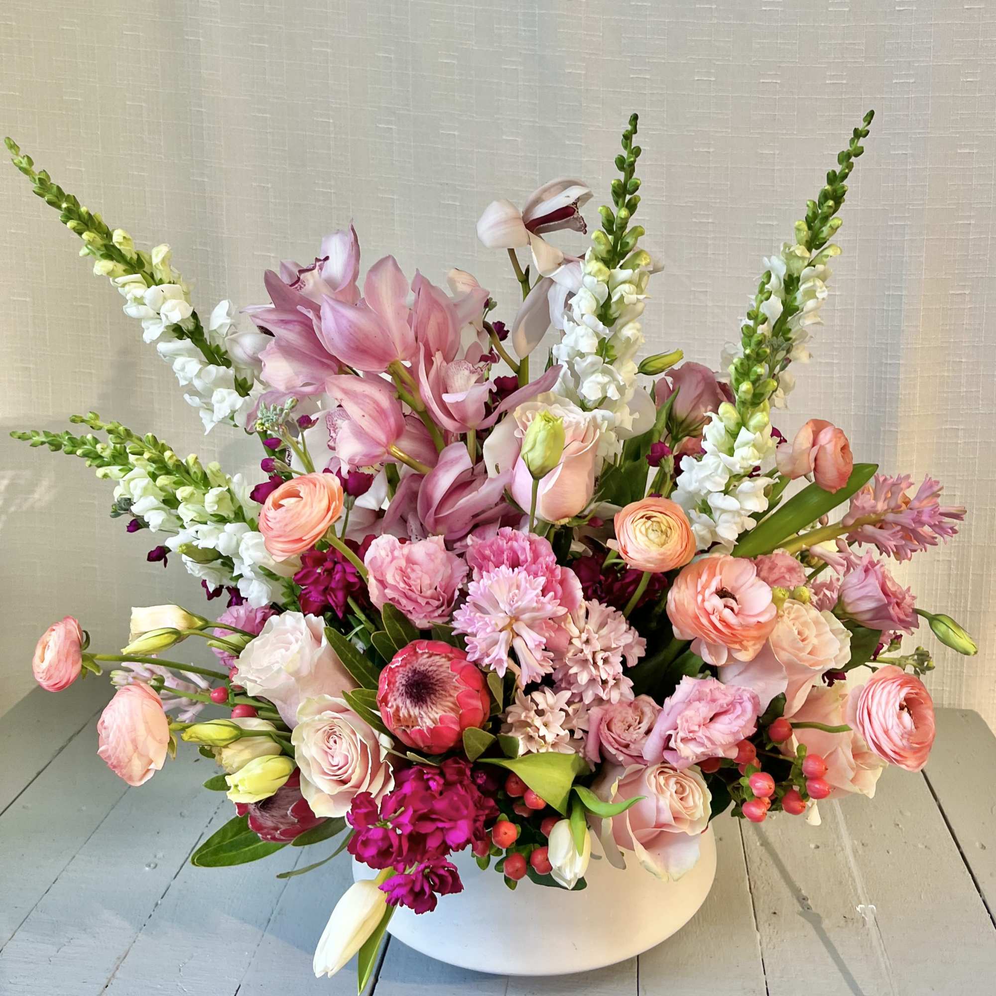 Hearts Aflame is a lush arrangement composed of seasonal locally sourced flowers