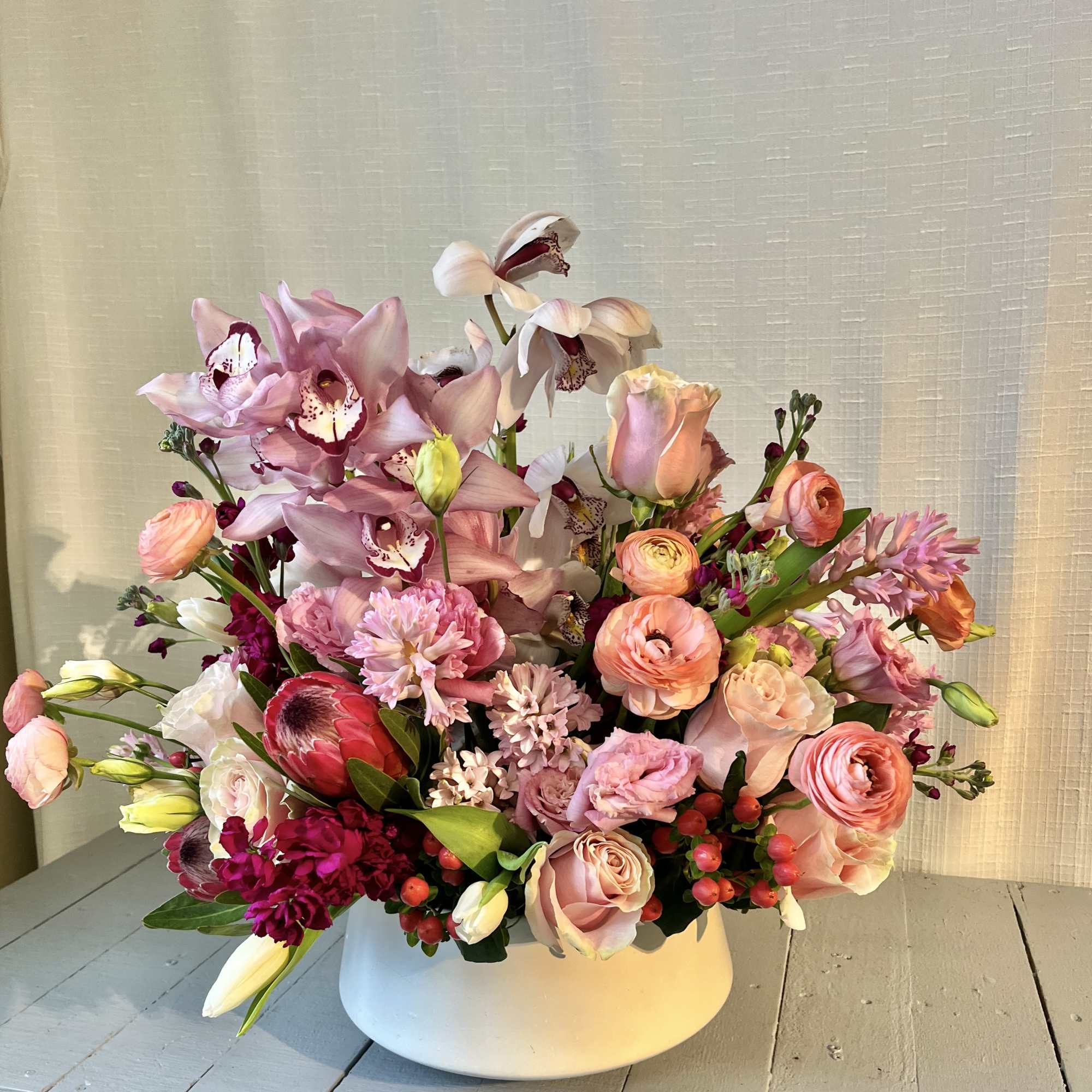 Hearts Aflame is a lush arrangement composed of seasonal locally sourced flowers