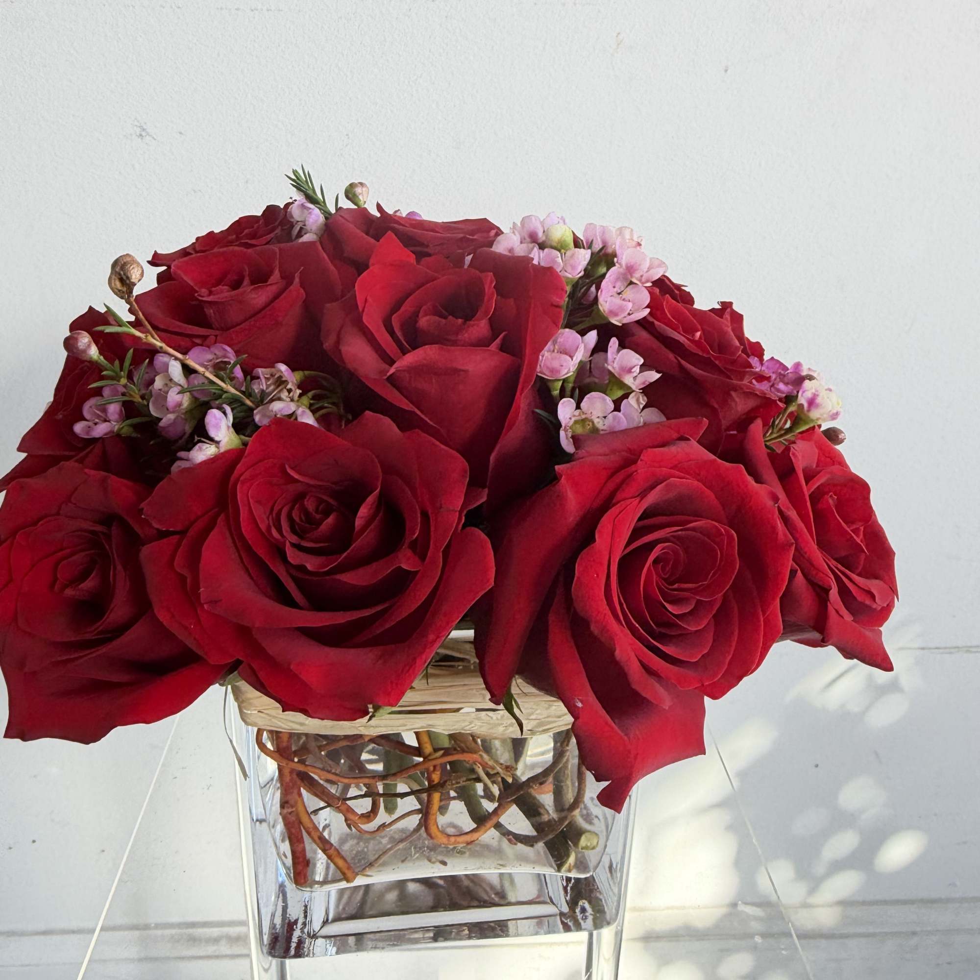 luxury Explorer Red Roses with a touch of curly willow and wax