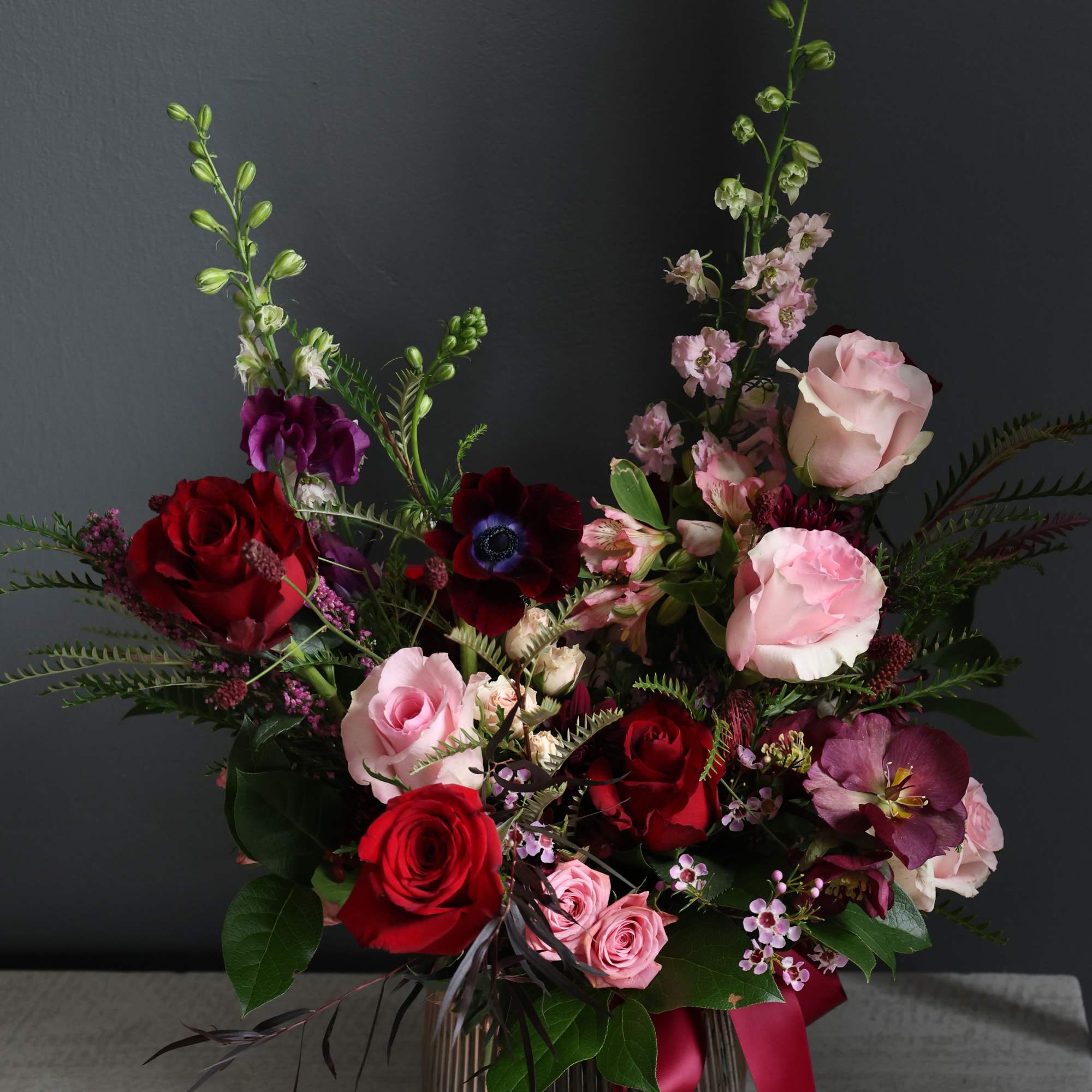 A beautiful mix of pink and red garden roses and carnations in