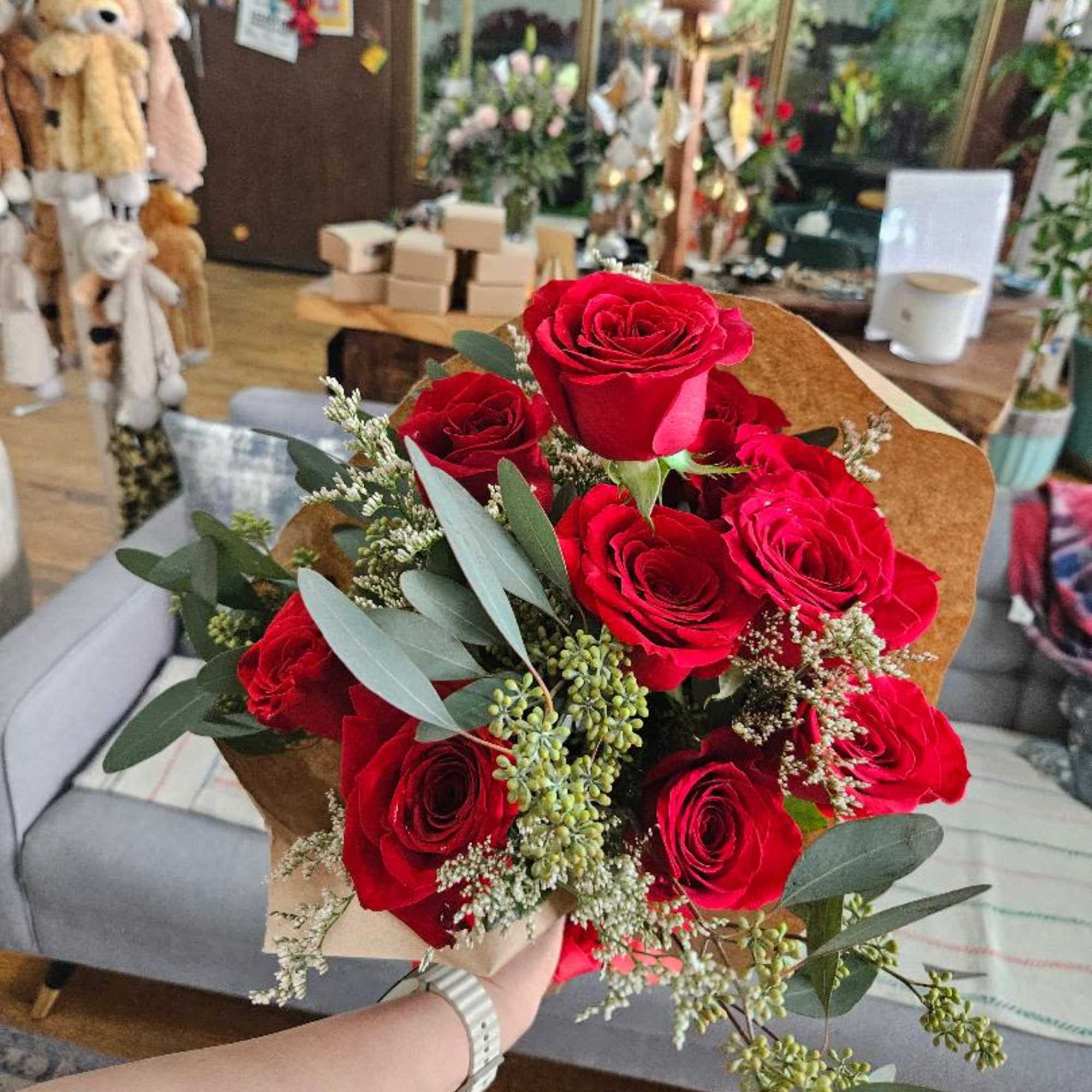 One dozen red roses wrapped in craft paper.