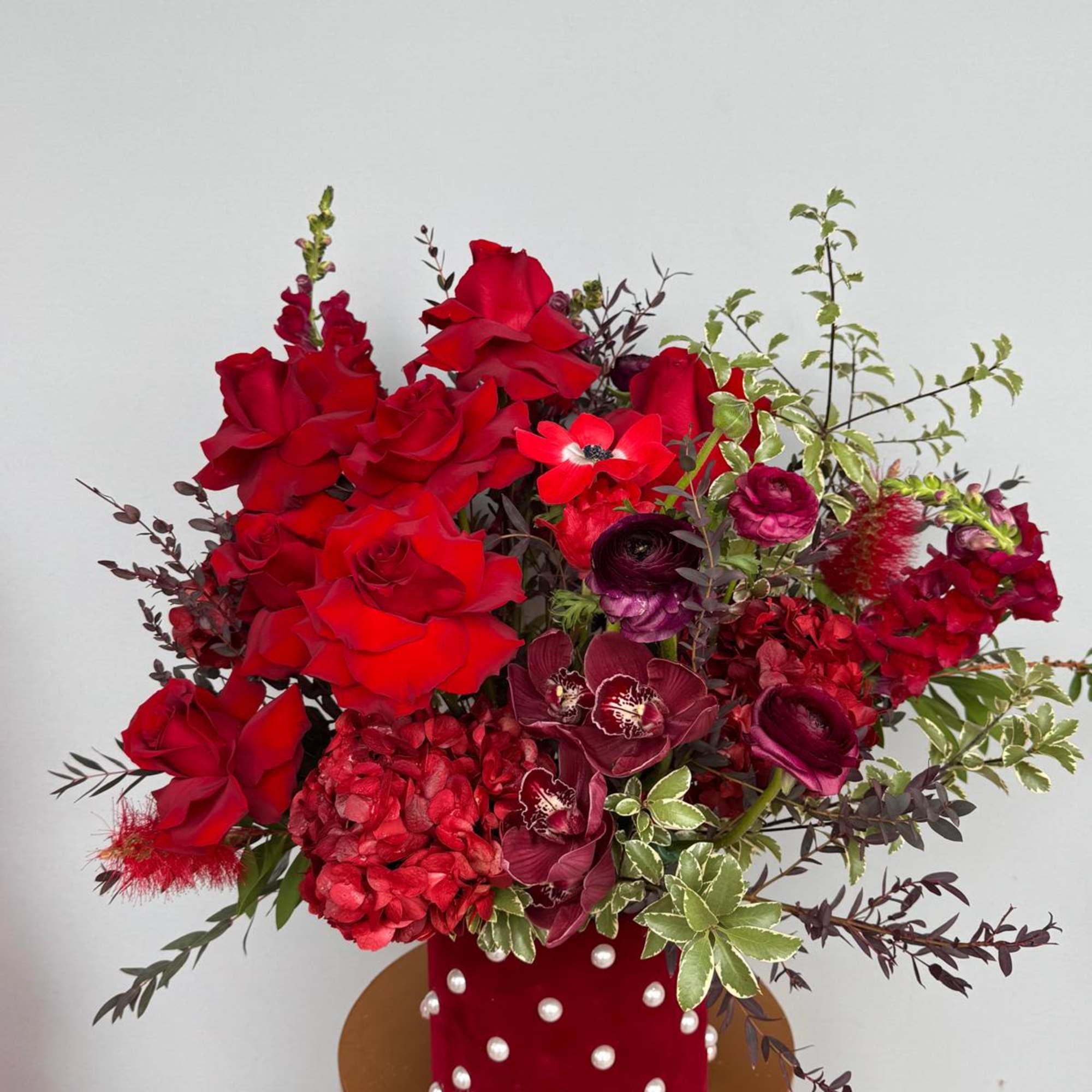 A luxurious mix of red roses and premium red blooms, artfully arranged